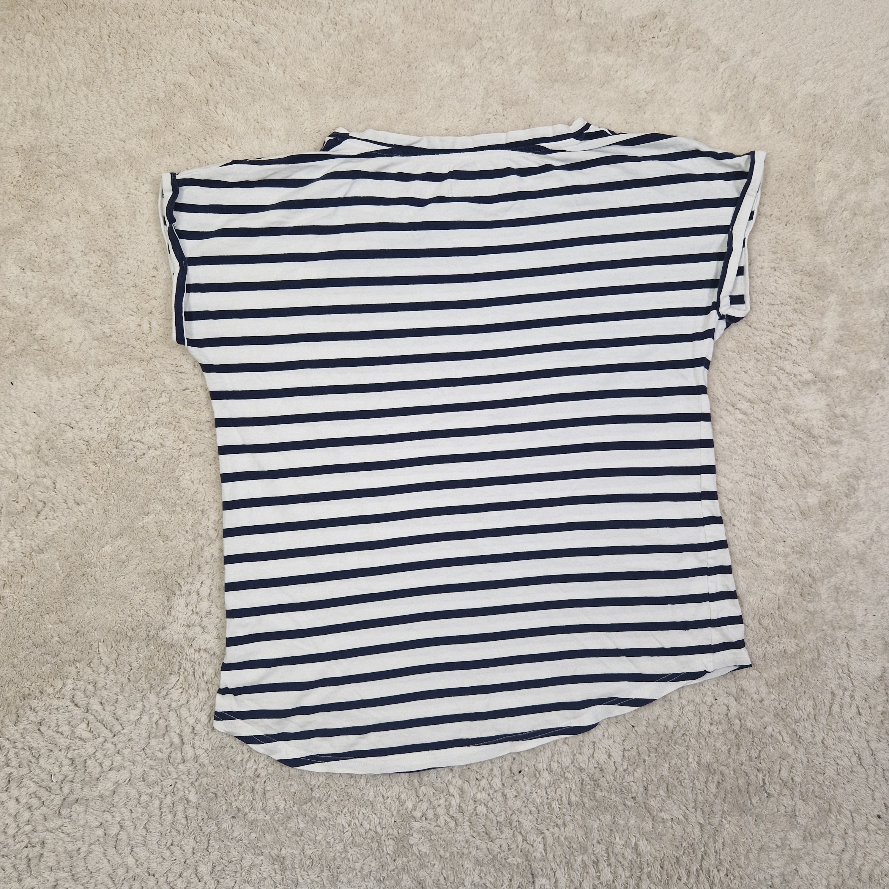 Striped shirt on a beige carpet