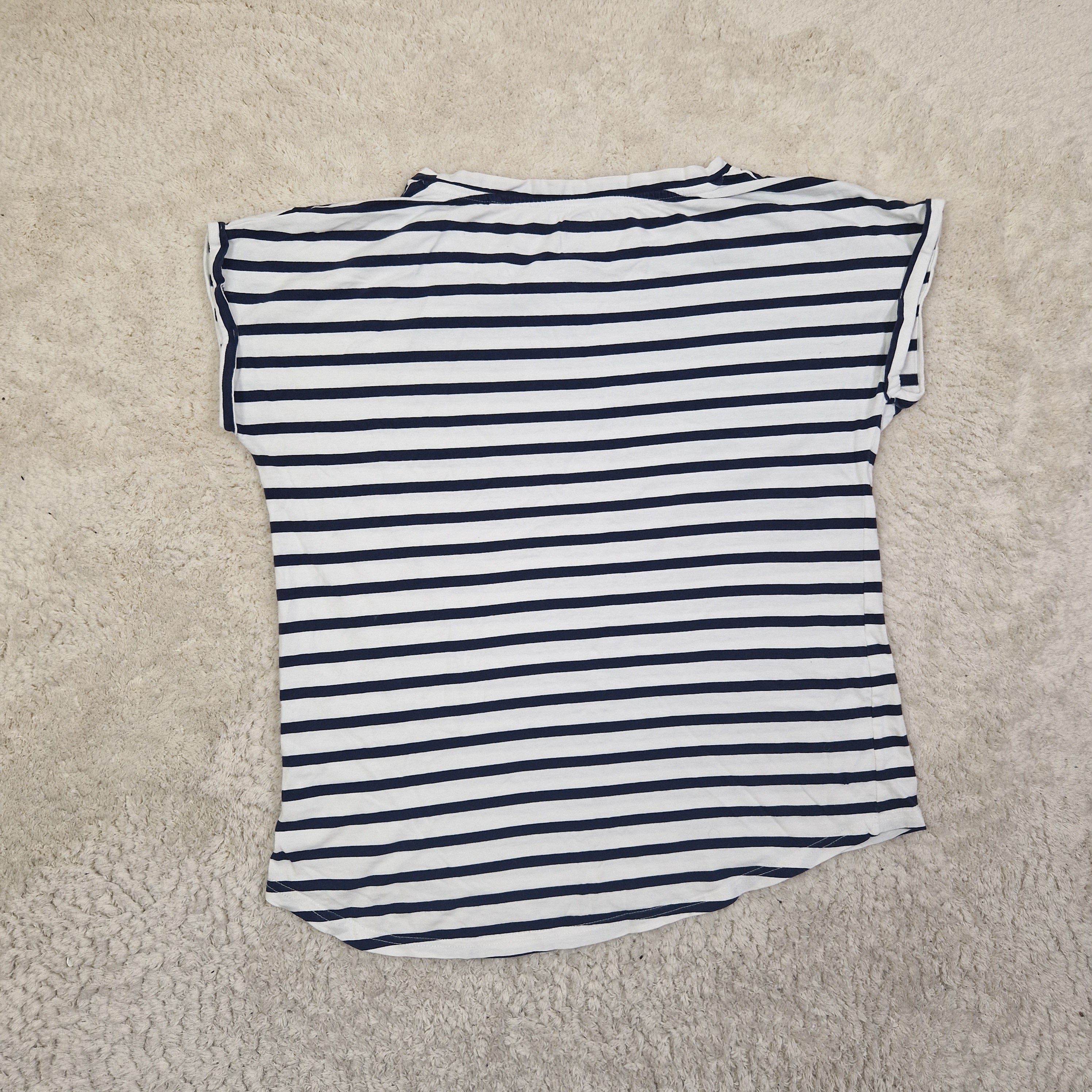 Striped shirt on a beige carpet