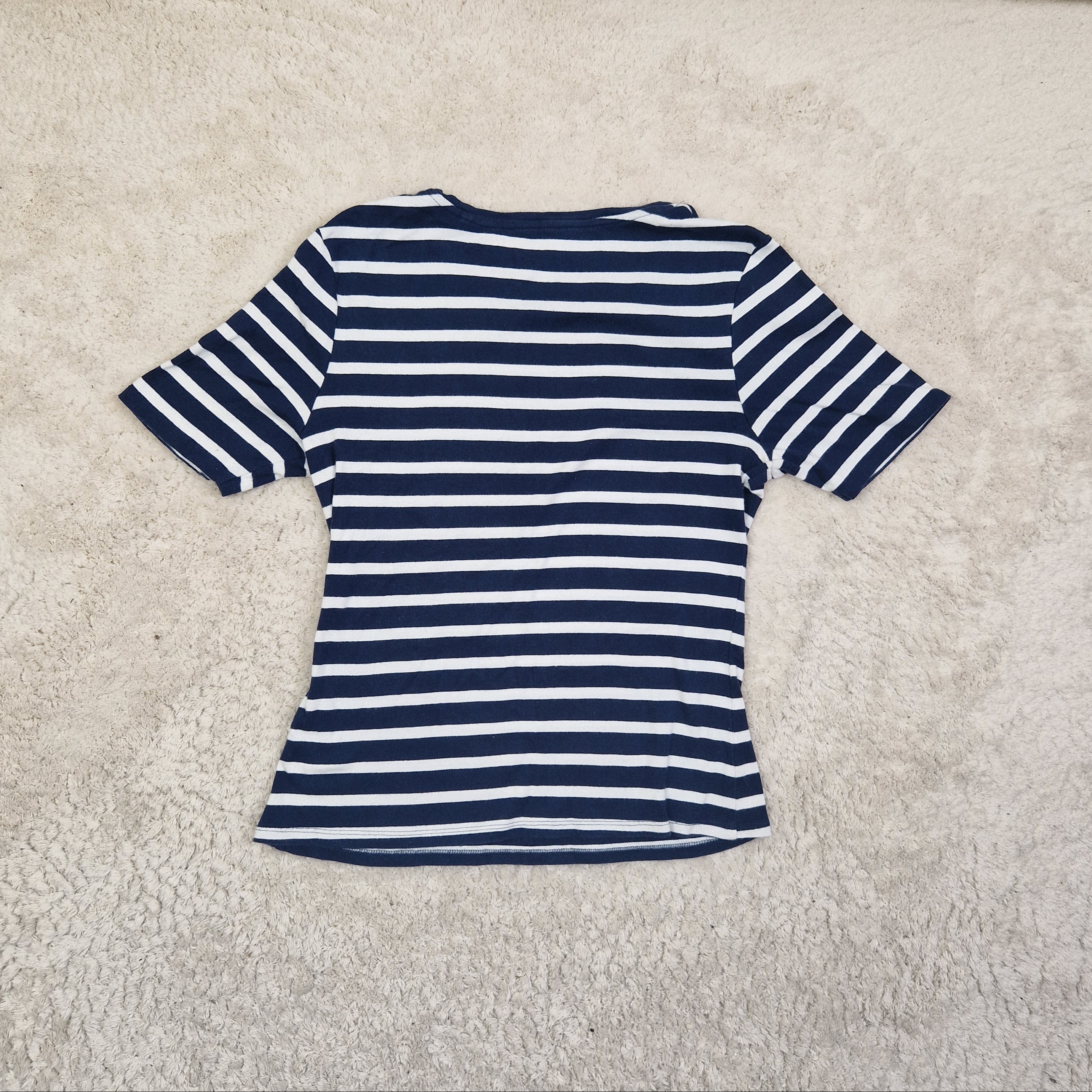 Navy and white striped shirt on a beige carpet