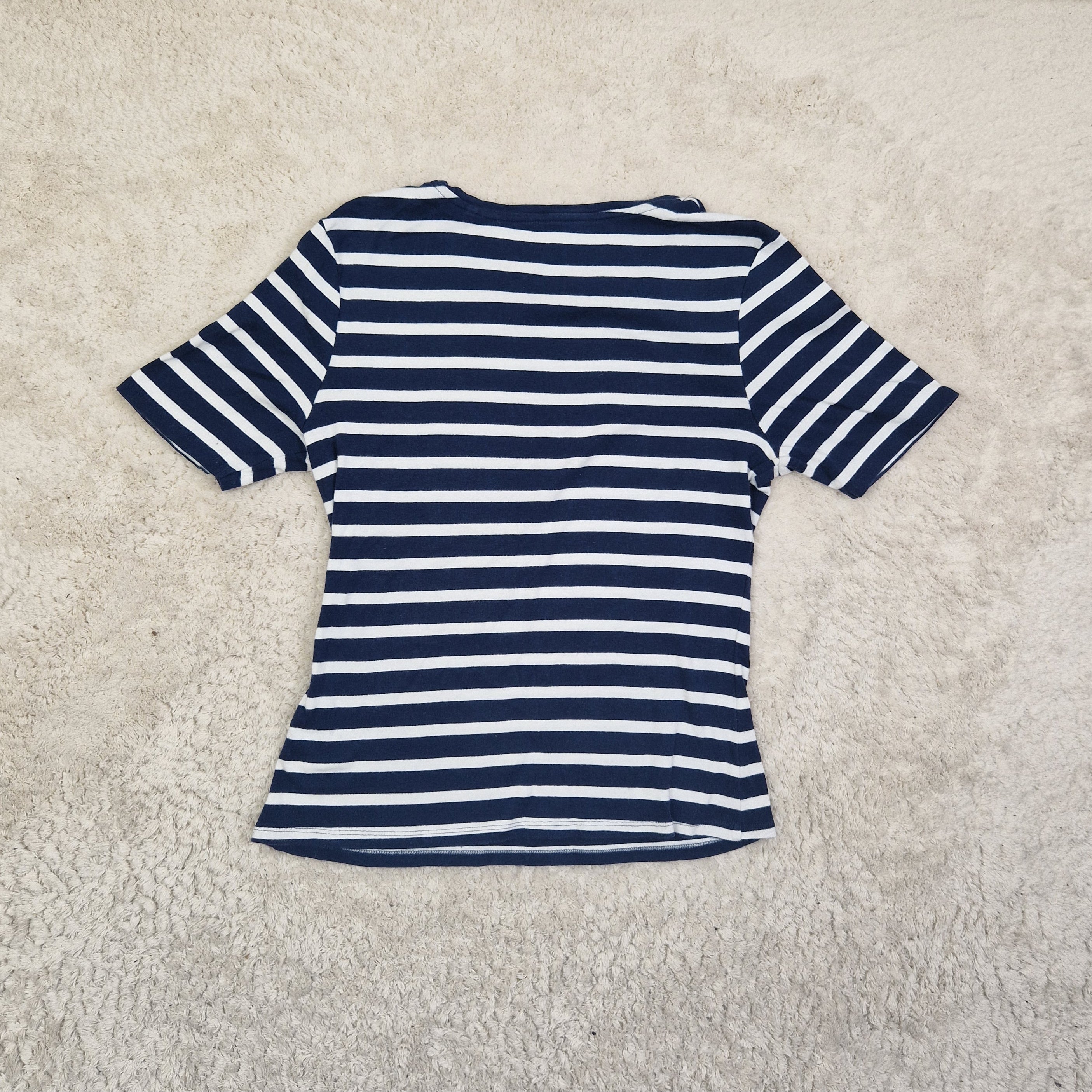 Navy and white striped shirt on a beige carpet