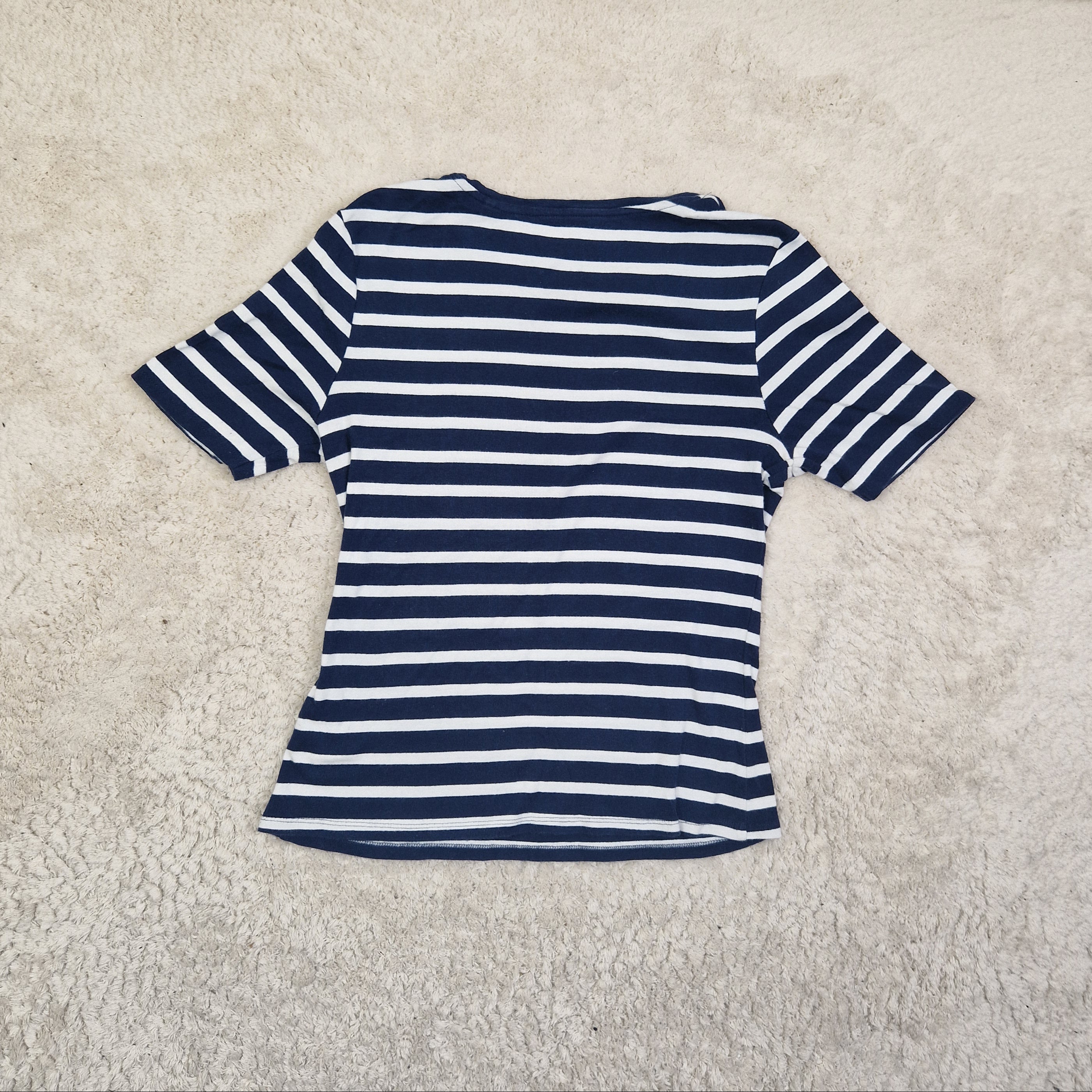 Navy and white striped garment on a beige carpet