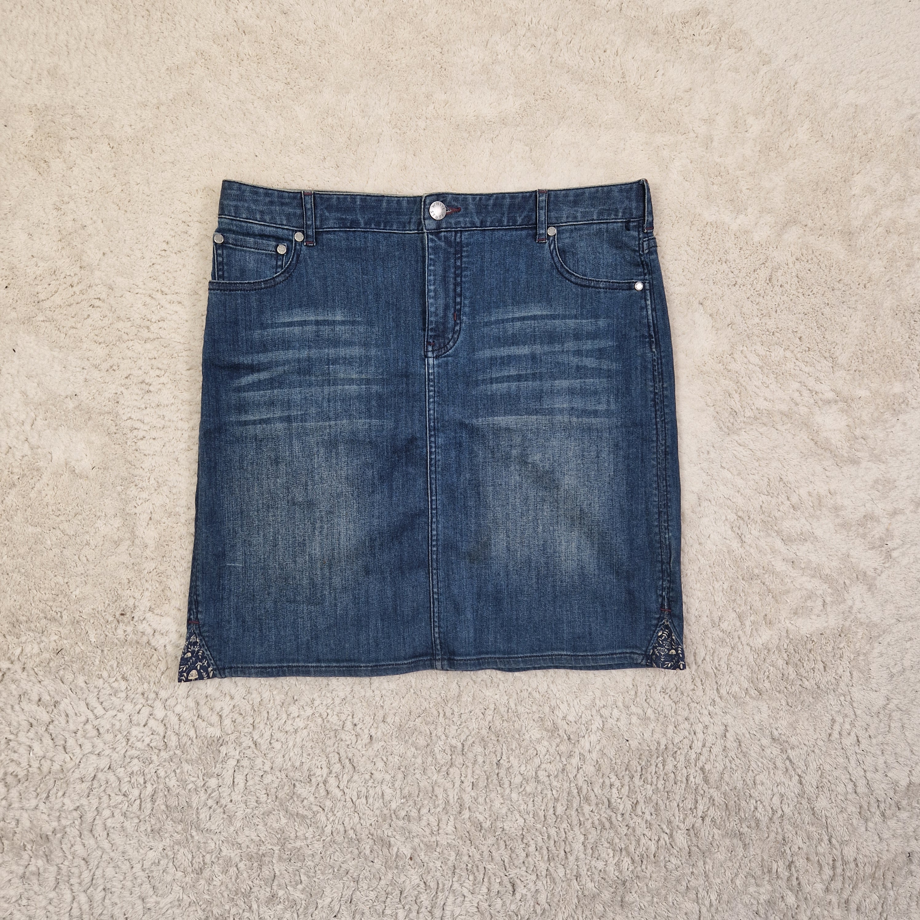 Blue denim skirt on a beige carpet
