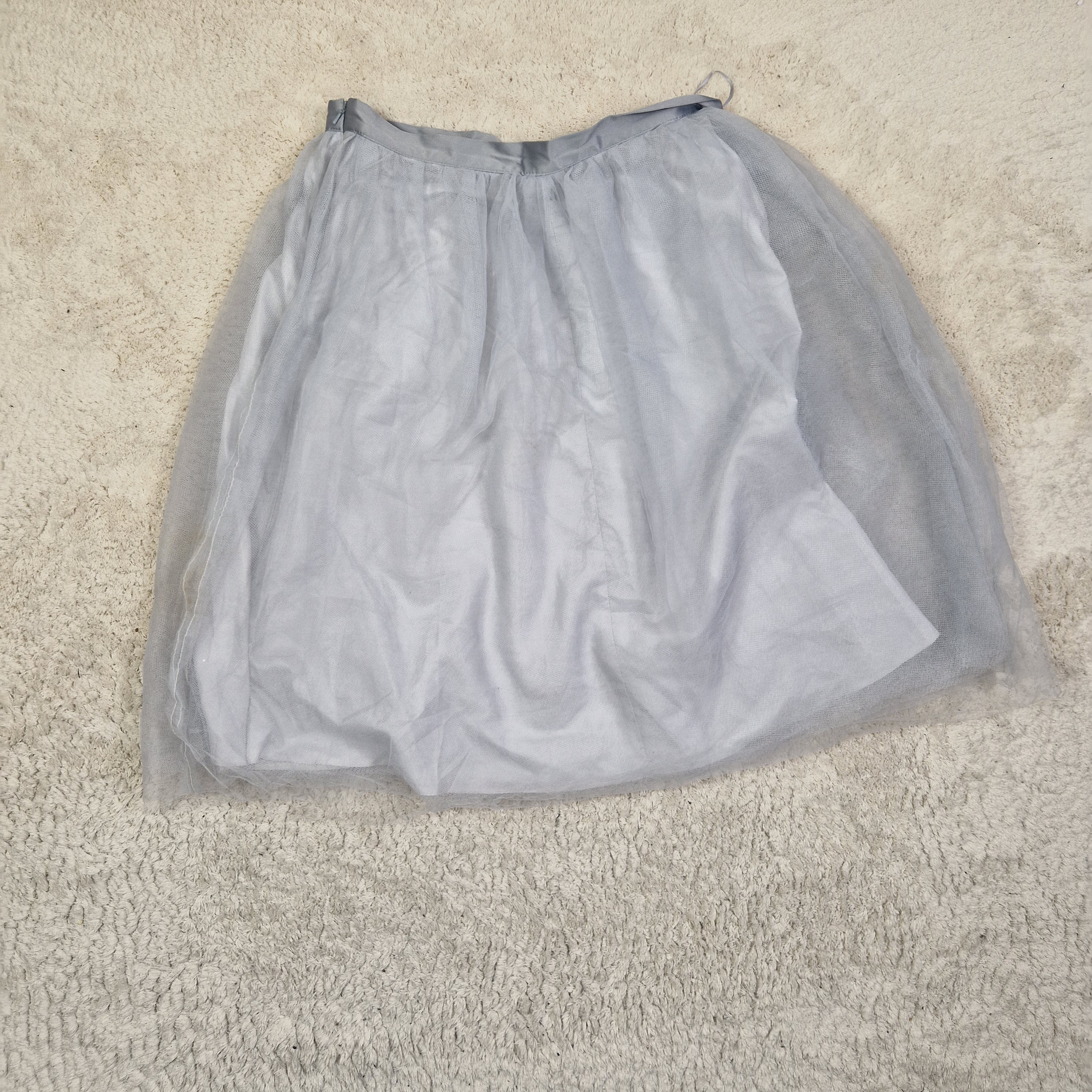 Gray mesh bag on a beige carpet
