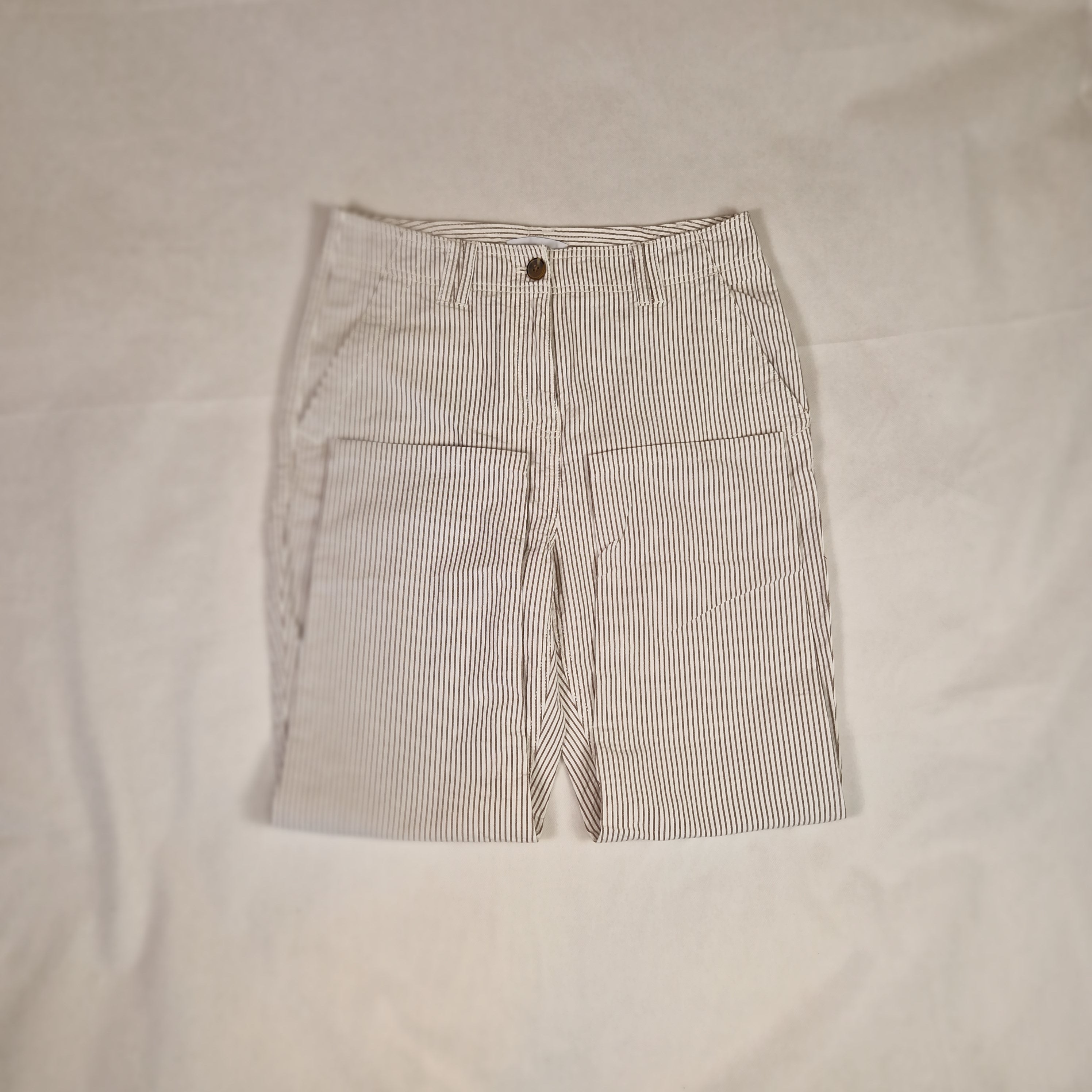 Folded striped shirt on a beige surface