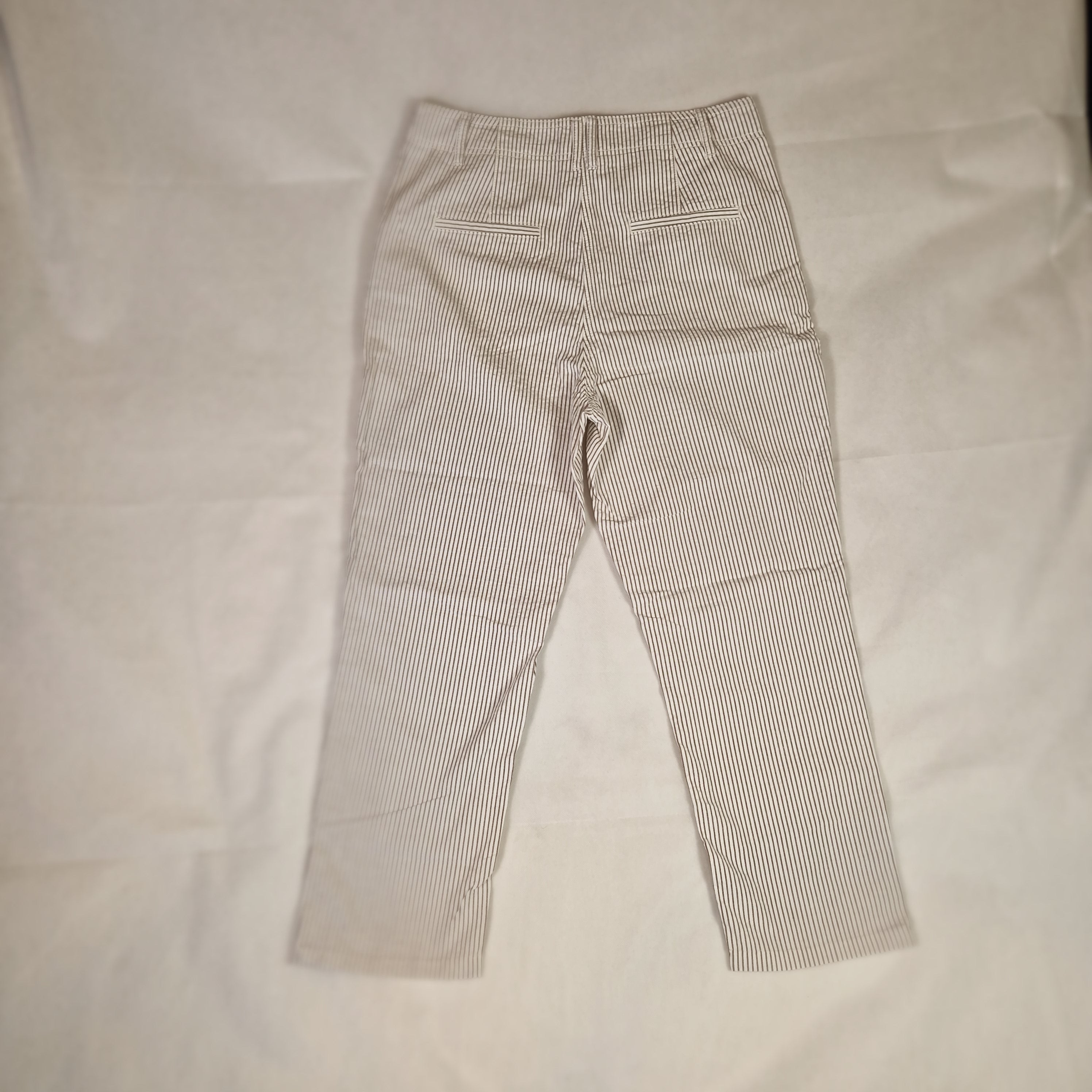 Folded gray striped pants on a light background
