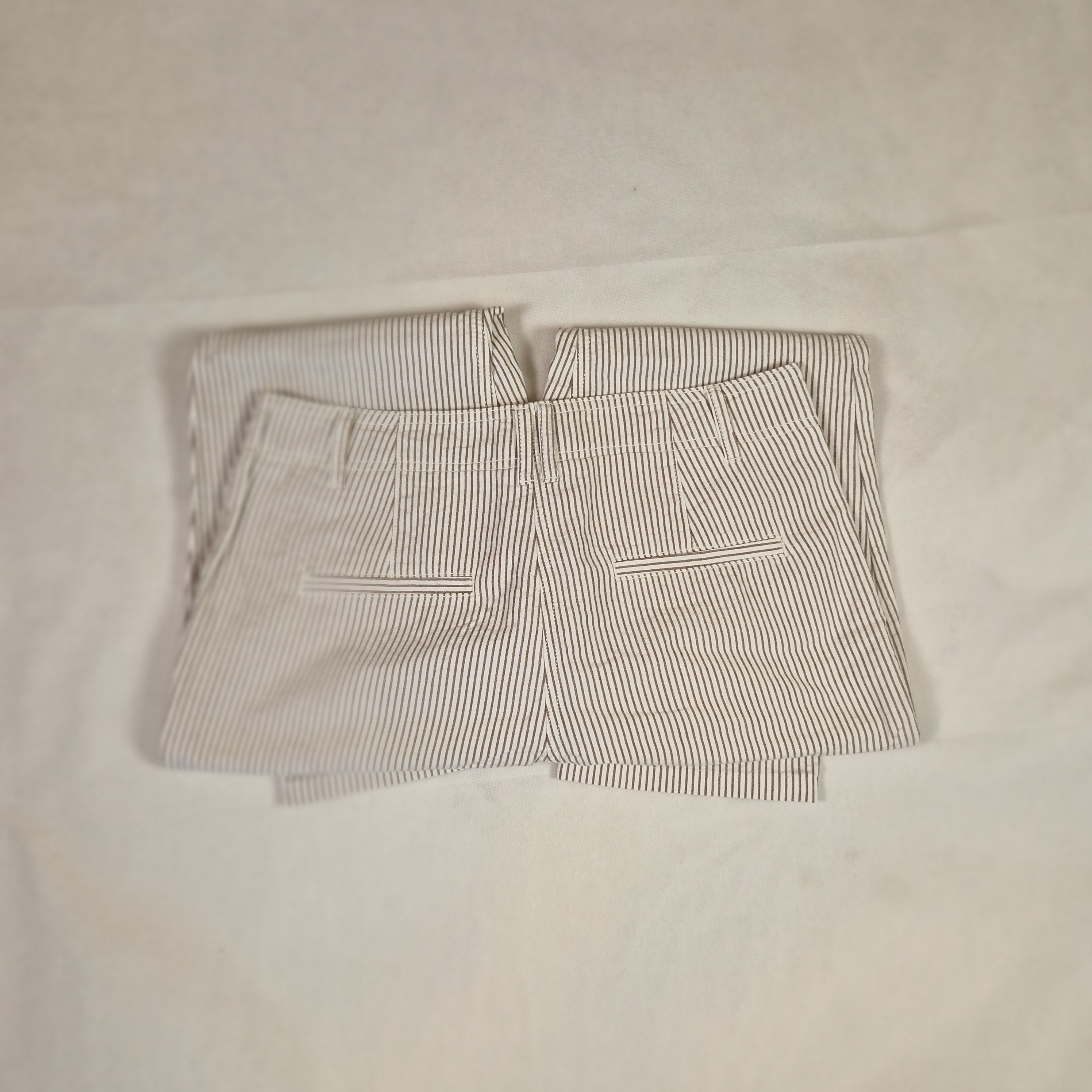 Folded striped fabric on a plain background