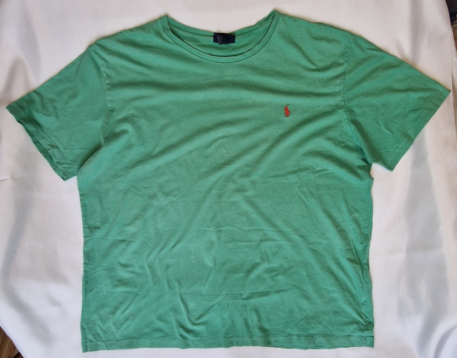 A green Ralph Lauren men's cotton t-shirt with a red logo and short sleeves.