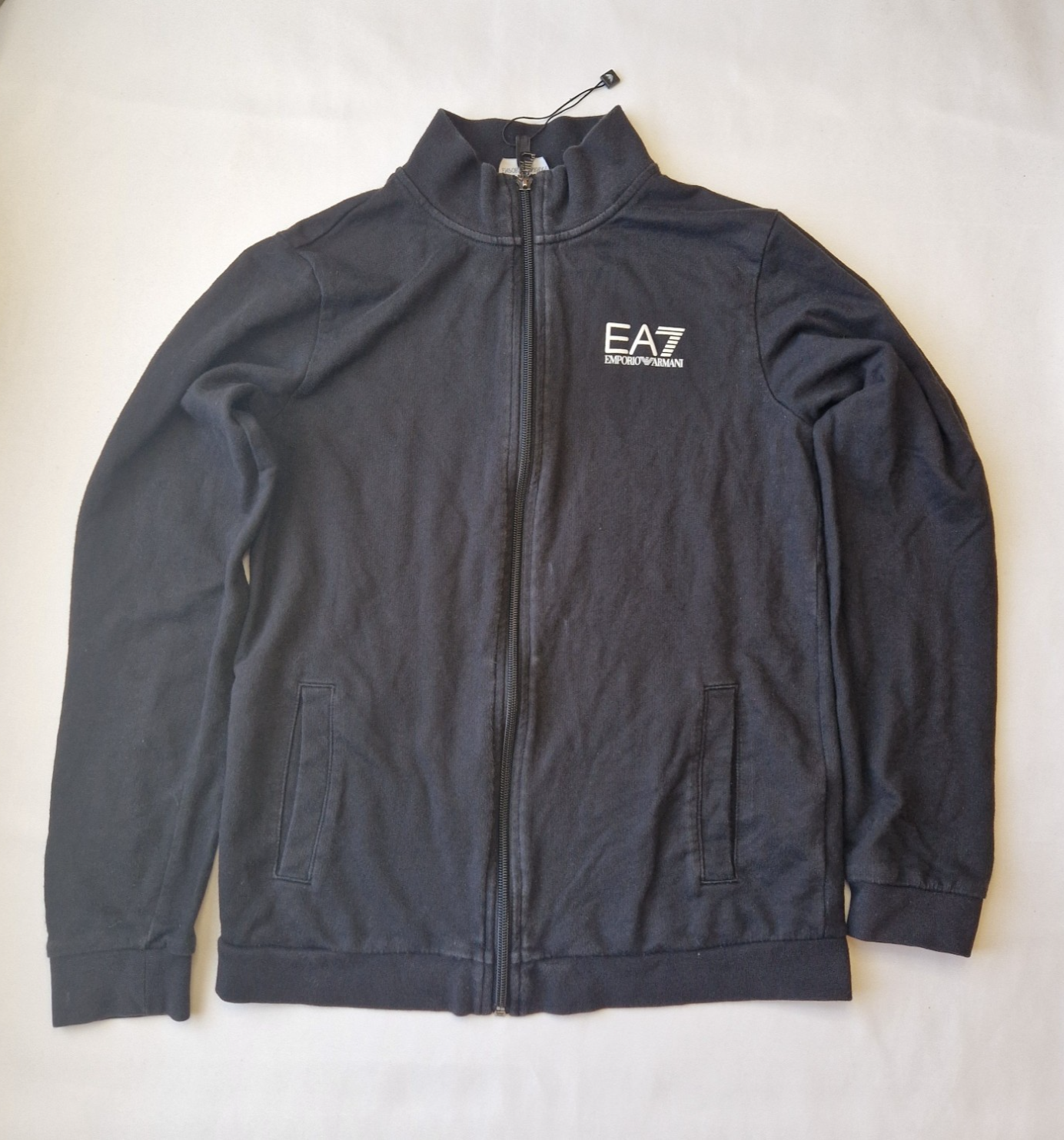 A black EA7 Emporio Armani junior zip-up bomber jacket with a stand-up collar and logo branding.