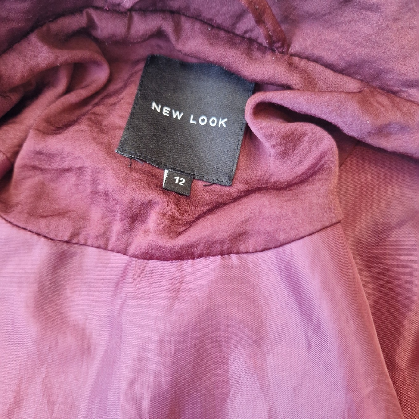 A maroon New Look lightweight softshell bomber jacket with a size 12 label.