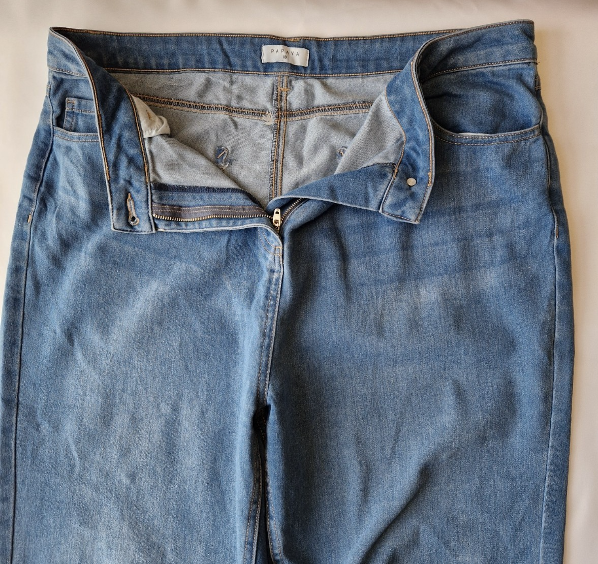 Papaya high-rise wide leg jeans in a medium blue wash with a zip and button closure.