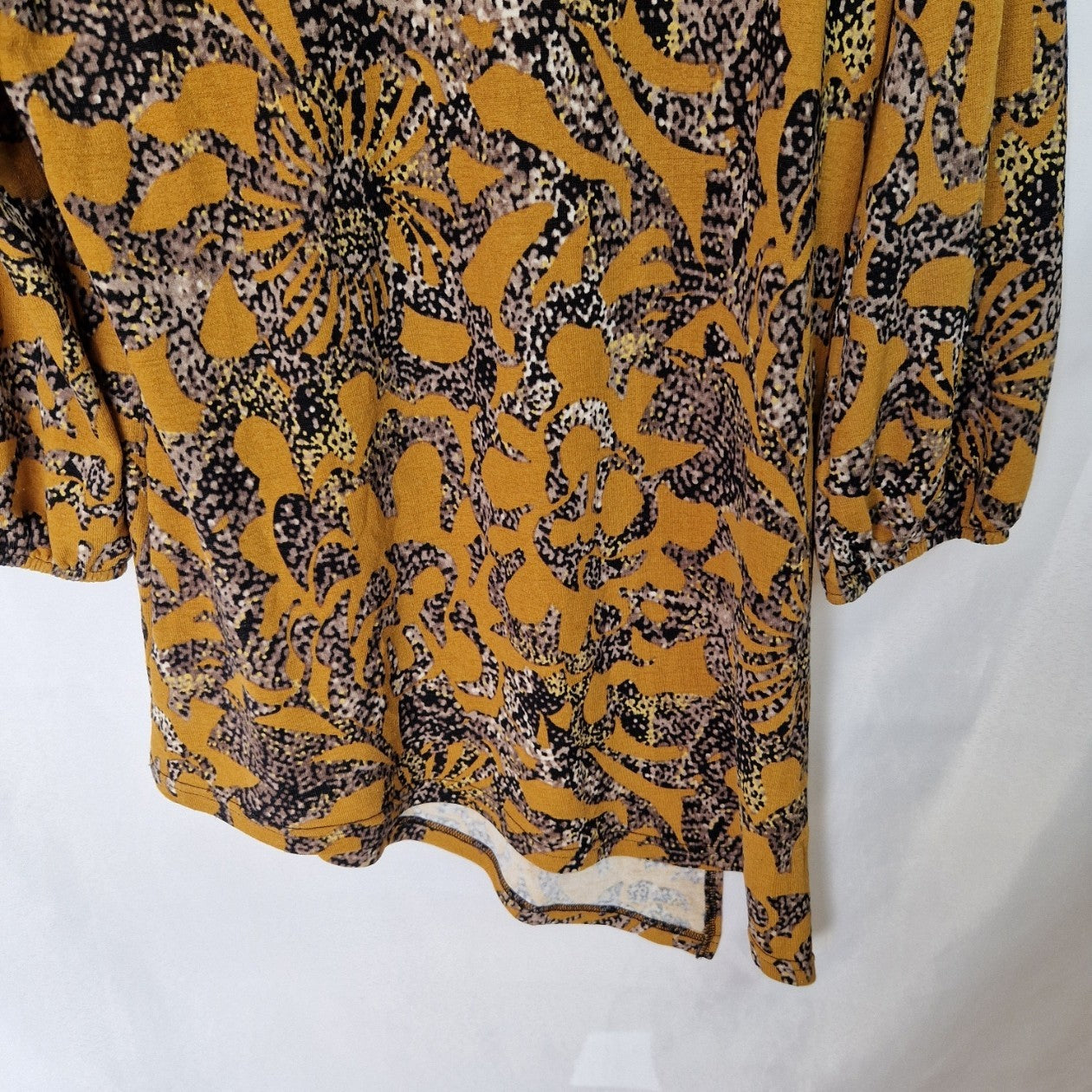 Klass yellow long-sleeve tunic top featuring a black and grey abstract print and asymmetric hem.