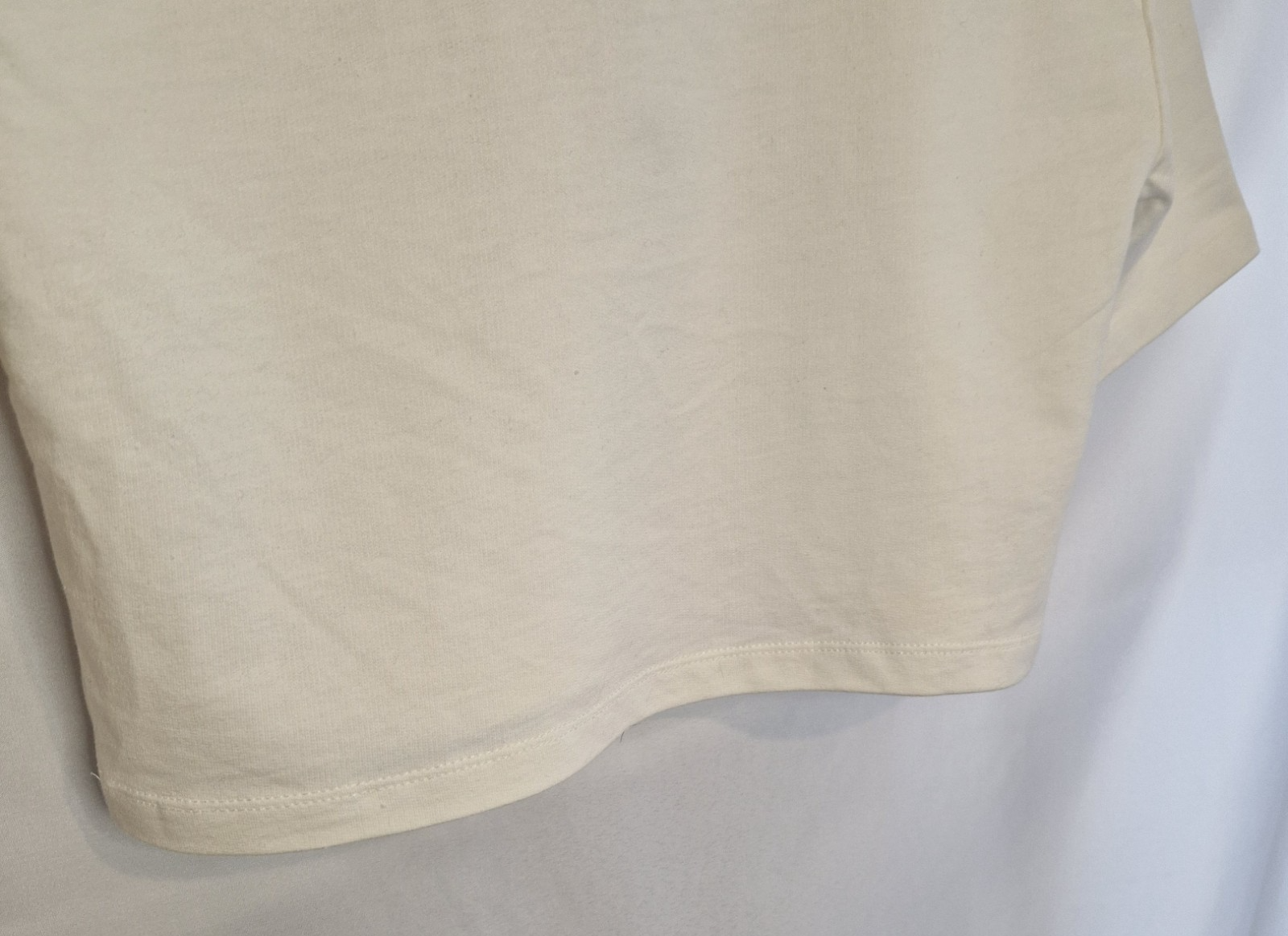 A plain white short-sleeved cotton t-shirt with a round neckline.