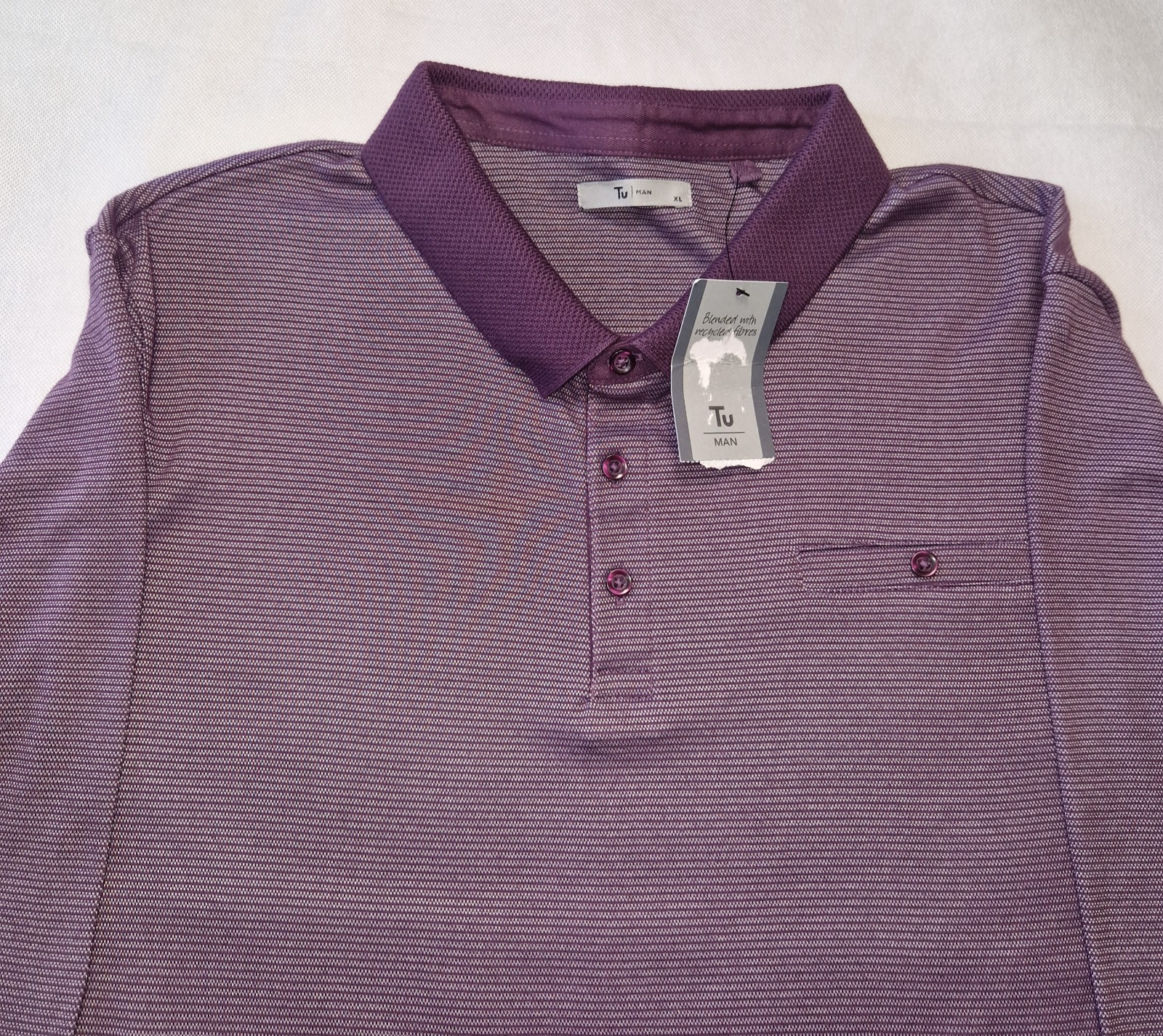 A purple long-sleeved polo shirt with a textured collar and a small chest pocket.