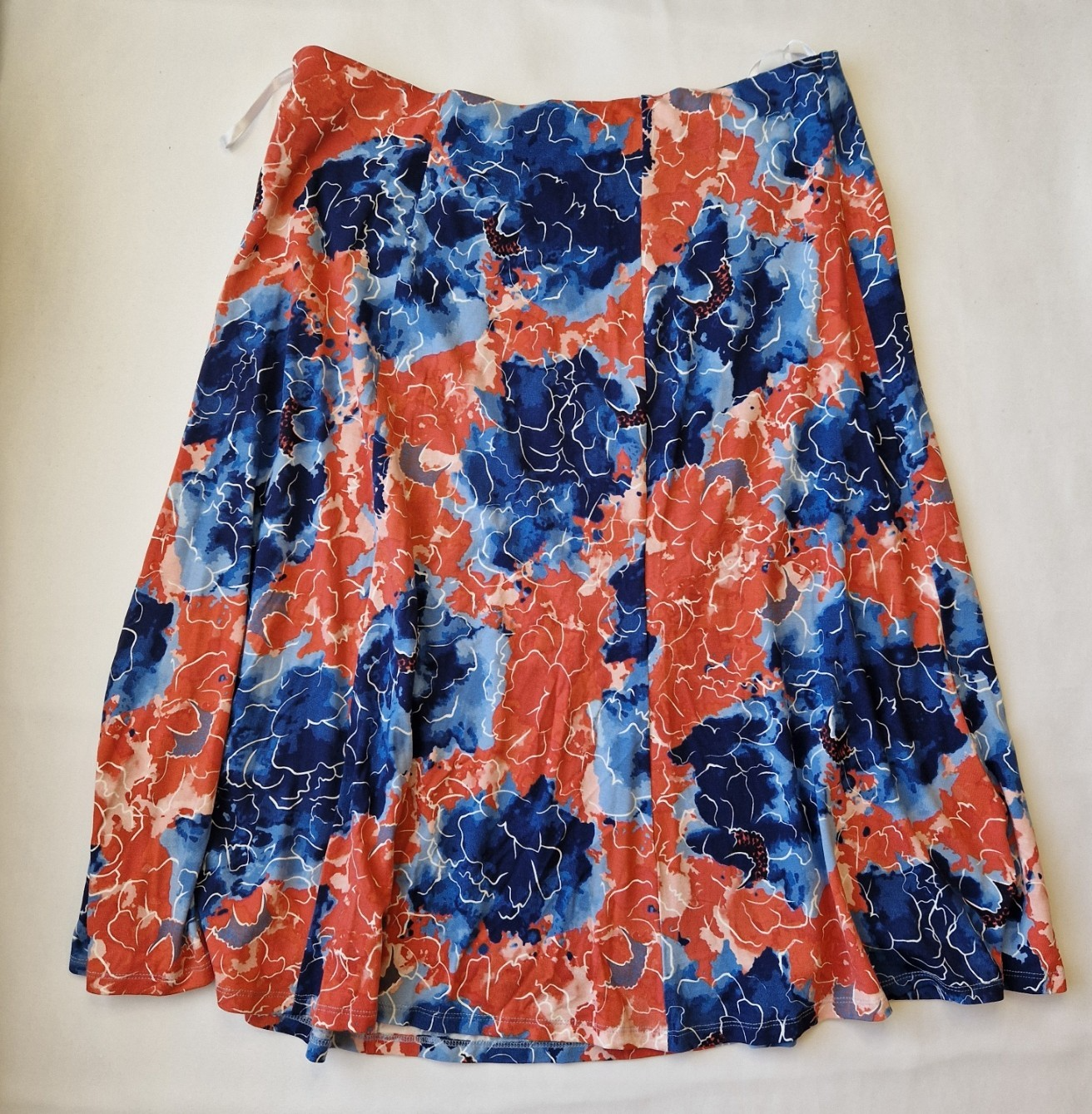 Honor Milburn midi skirt in a multicolour floral print with an asymmetric hem.