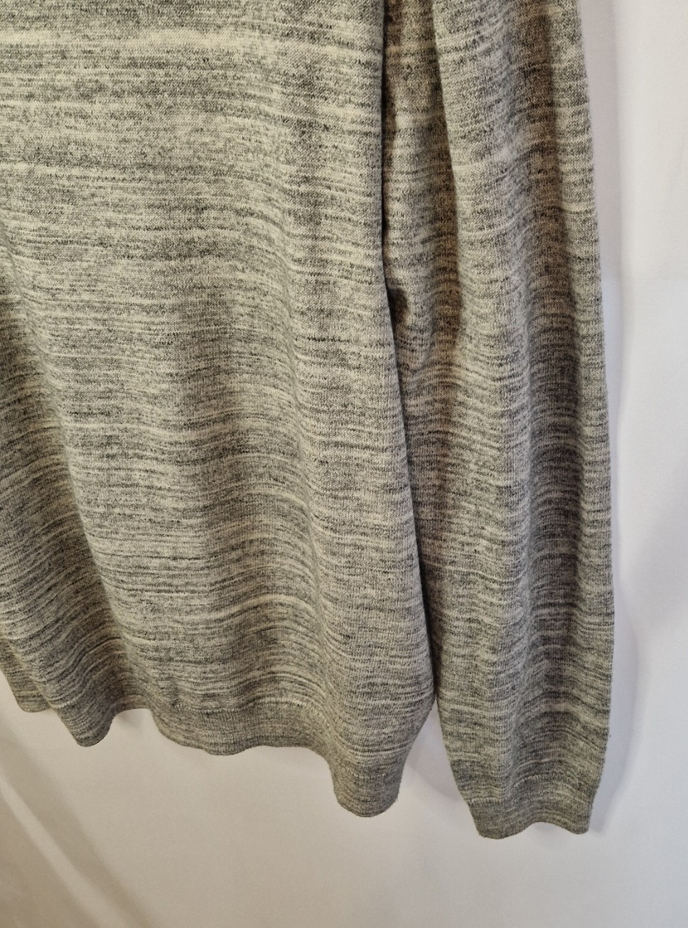 A grey long-sleeve knit pullover with a textured marl finish.