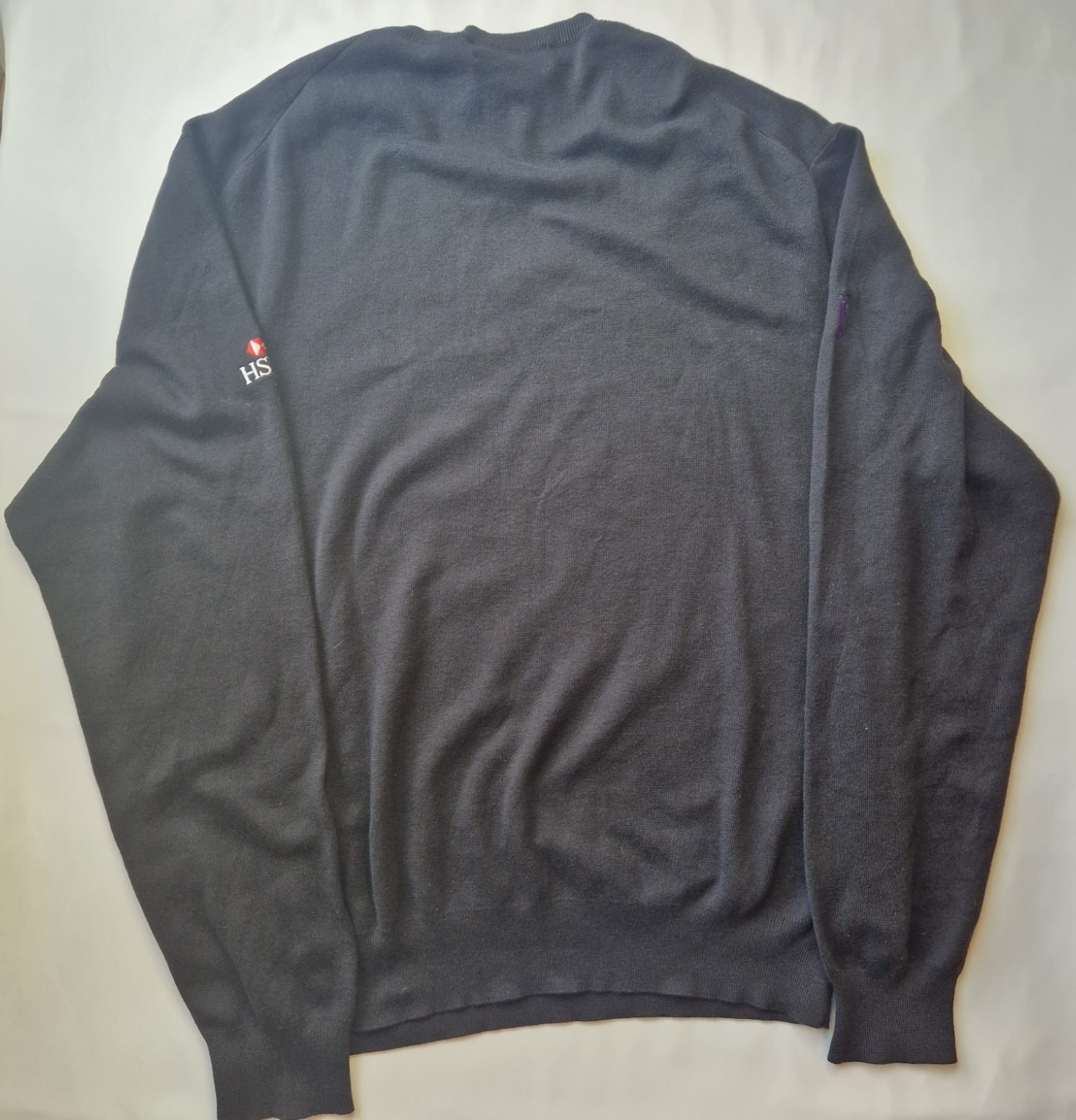 A black Ralph Lauren V-neck cotton sweater featuring an embroidered HSBC logo on the sleeve.