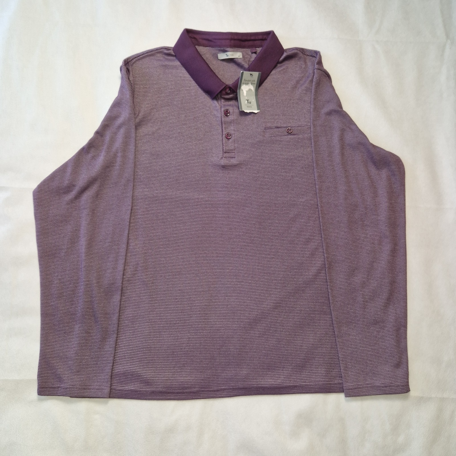 A purple long-sleeved polo shirt with a textured collar and a small chest pocket.