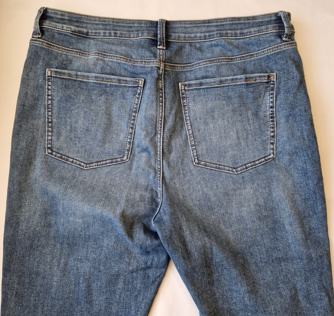 Back view of Marks and Spencer mid-rise blue stretch denim skinny jeans with five pockets.