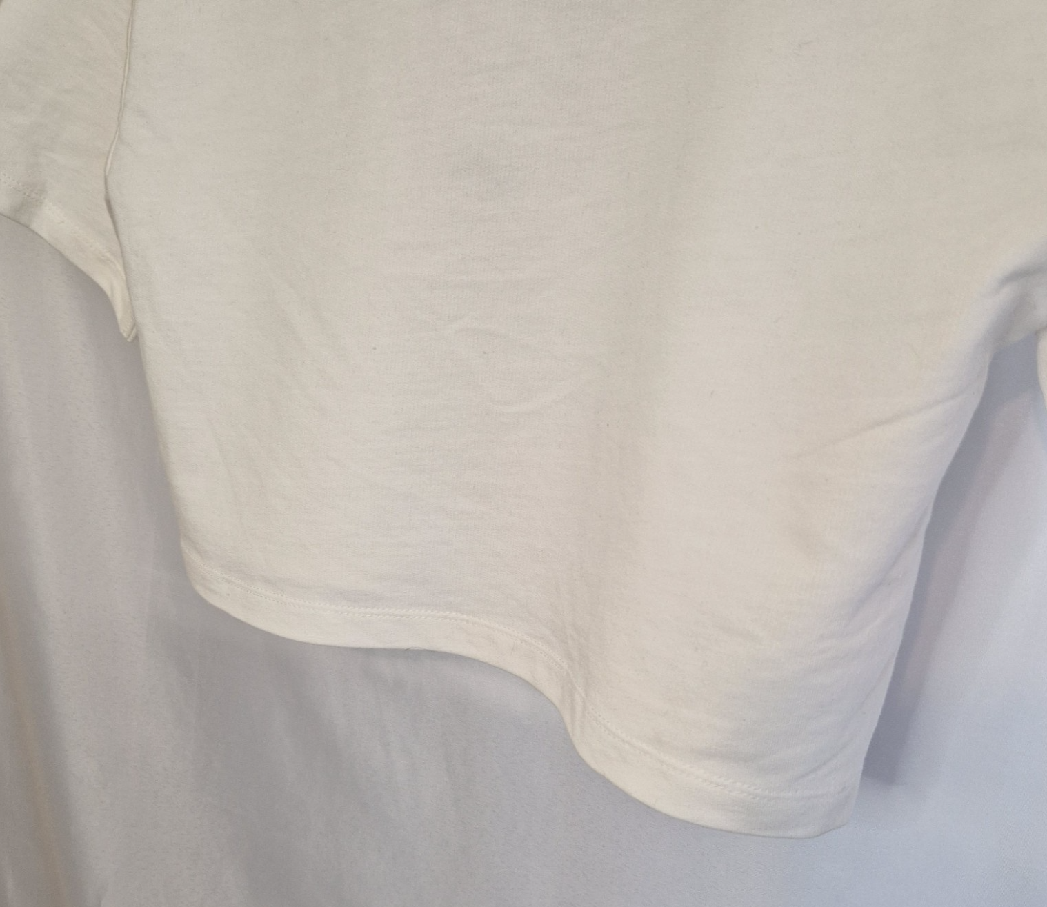 A plain white short-sleeved cotton t-shirt with a round neckline.