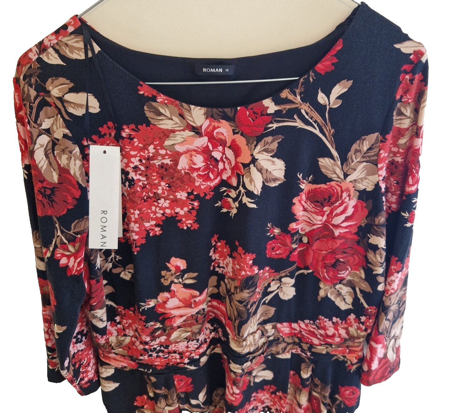 A black Roman fit and flare dress featuring a red floral print, long sleeves, and a round neckline.