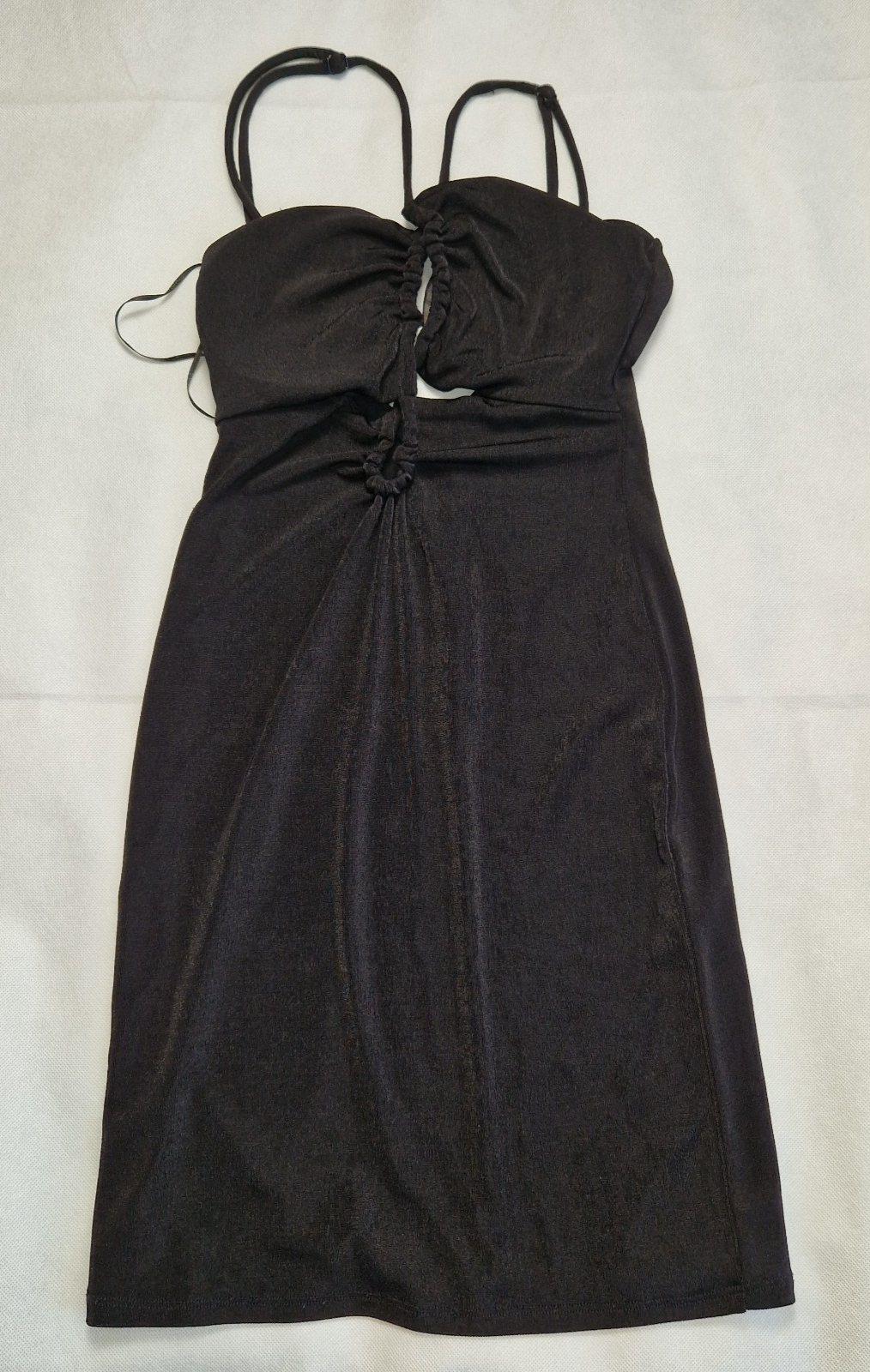 A black Bershka crop top featuring padded cups, thin adjustable straps, and a gathered front.