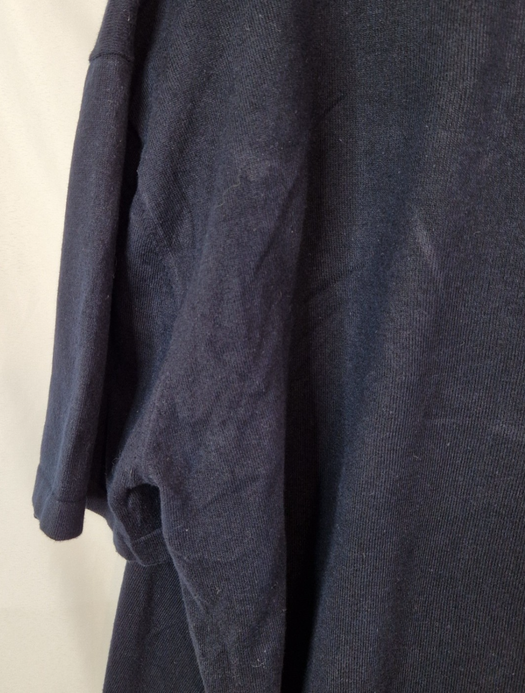 A dark blue Next men's short-sleeve cotton V-neck polo shirt.