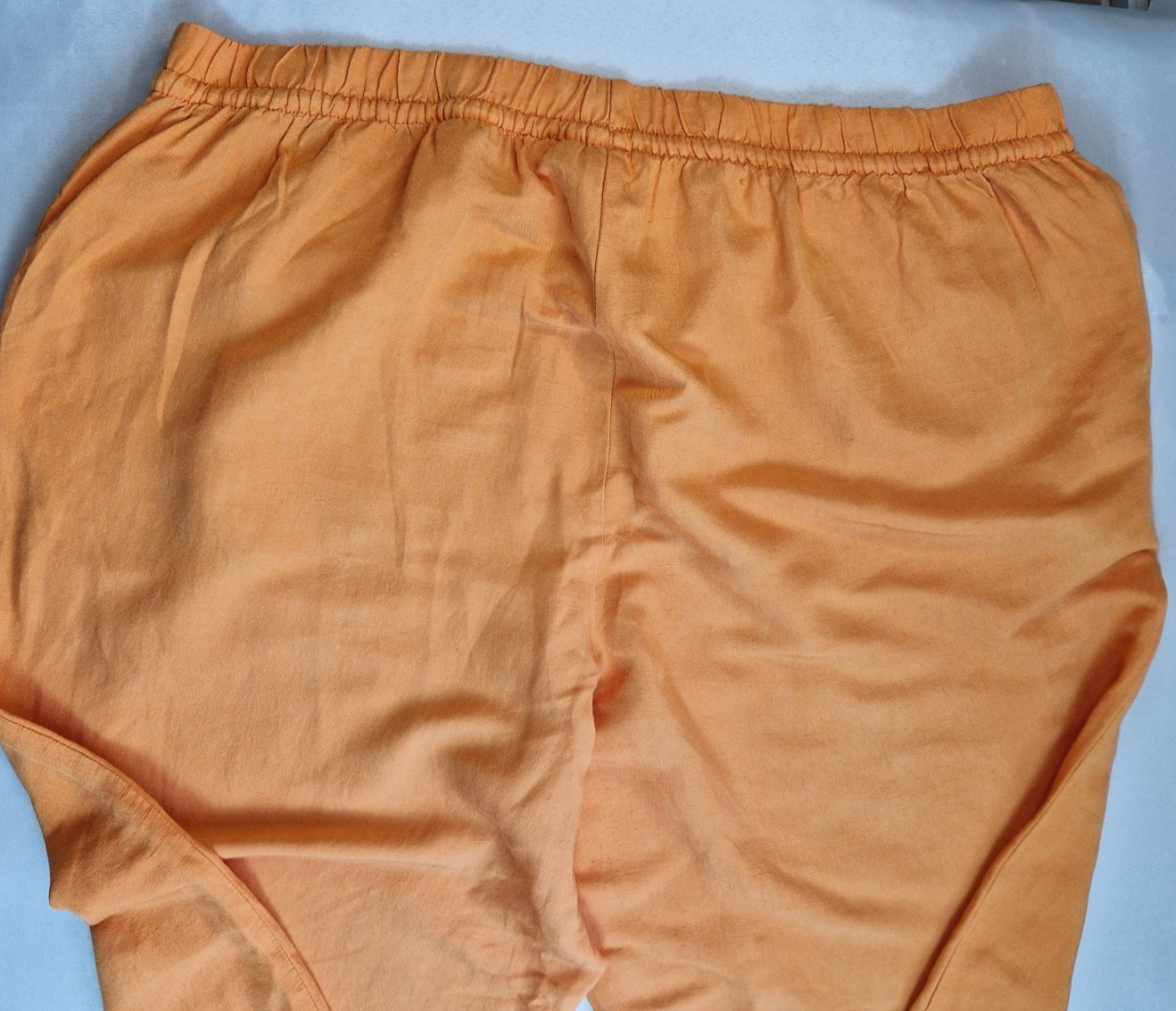 Orange H&M wide-leg jogger trousers with an elasticated waistband.