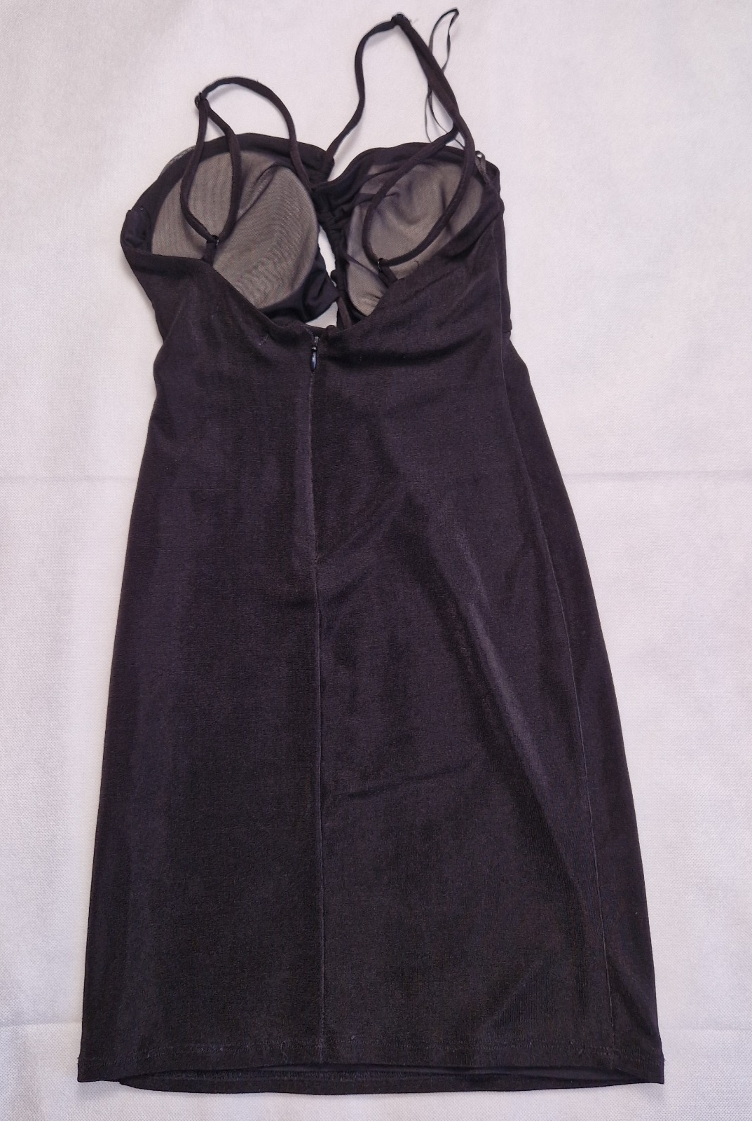 A black Bershka off-shoulder crop top with thin straps, integrated padding, and a back zip.