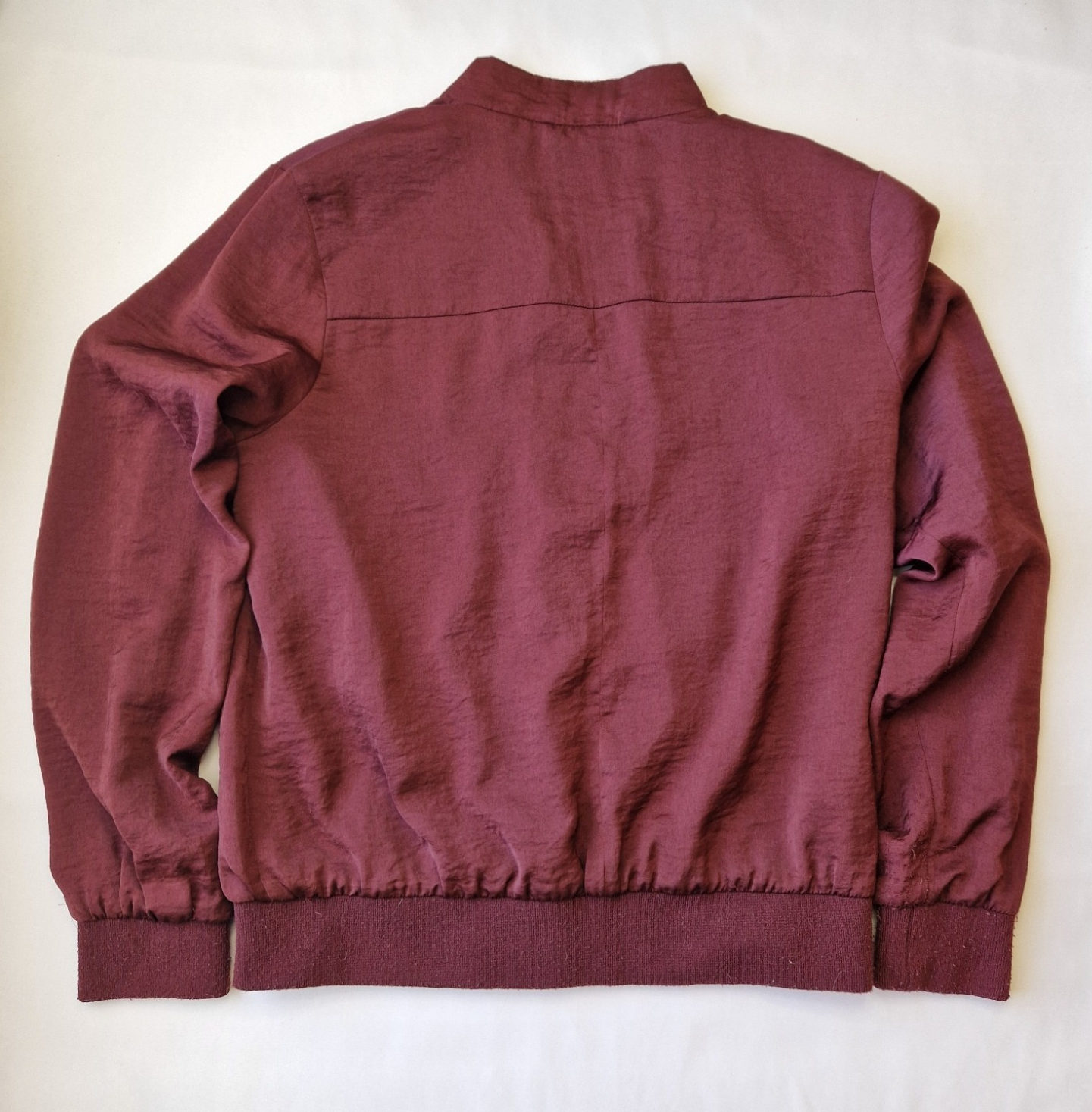 A maroon New Look women's lightweight bomber jacket with long sleeves and a ribbed hem.