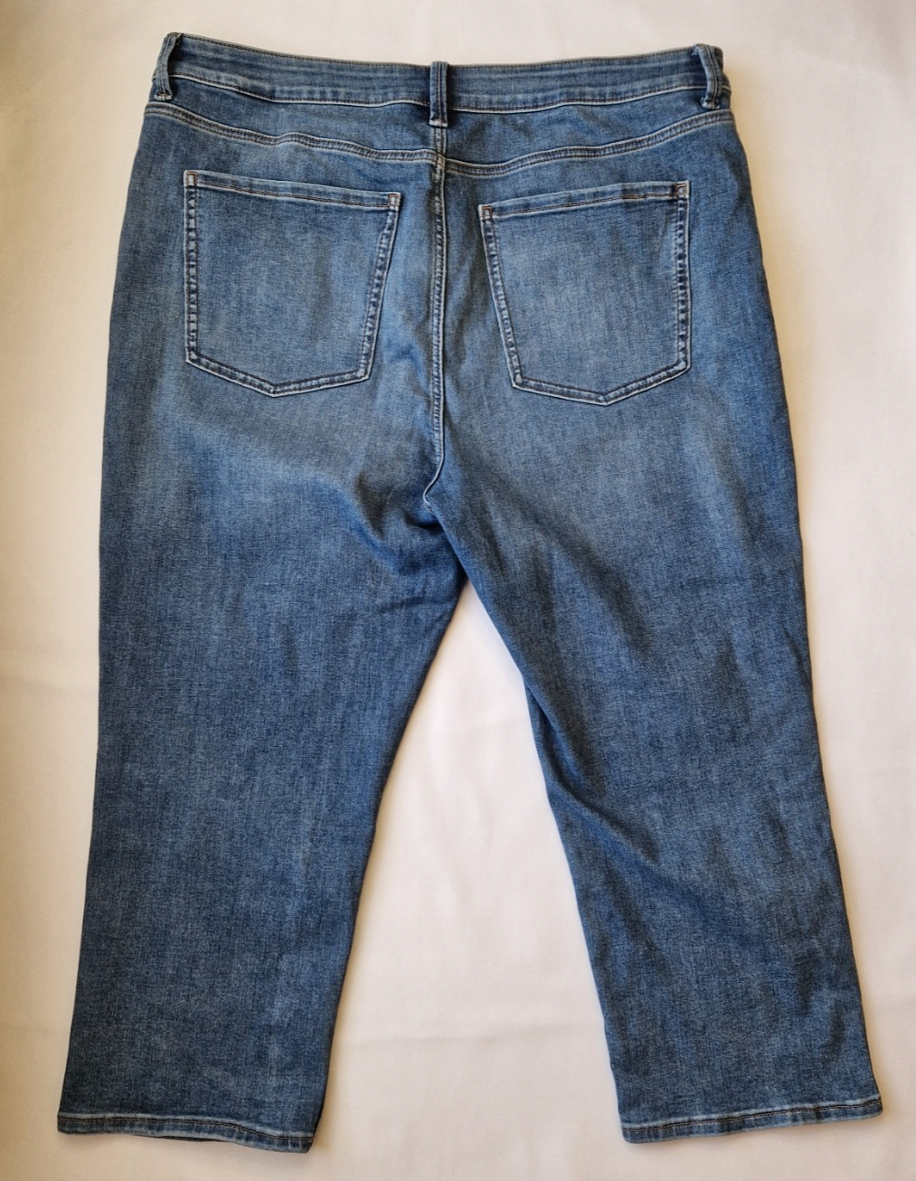 Back view of Marks and Spencer mid-rise blue stretch denim skinny jeans with five pockets.