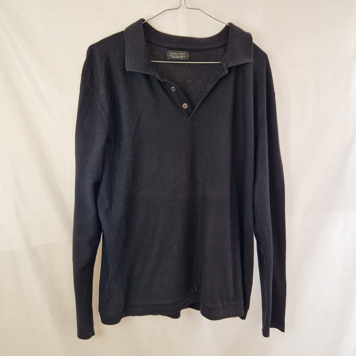 A black Zara Man long-sleeve knit polo sweater with a two-button placket.