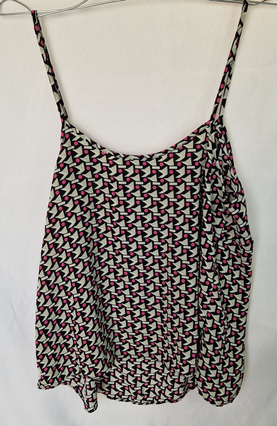 A sleeveless Papaya cami top in a geometric black, white, and pink chiffon print.