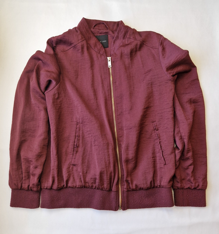 A maroon New Look lightweight bomber jacket with a full front zipper and ribbed cuffs.