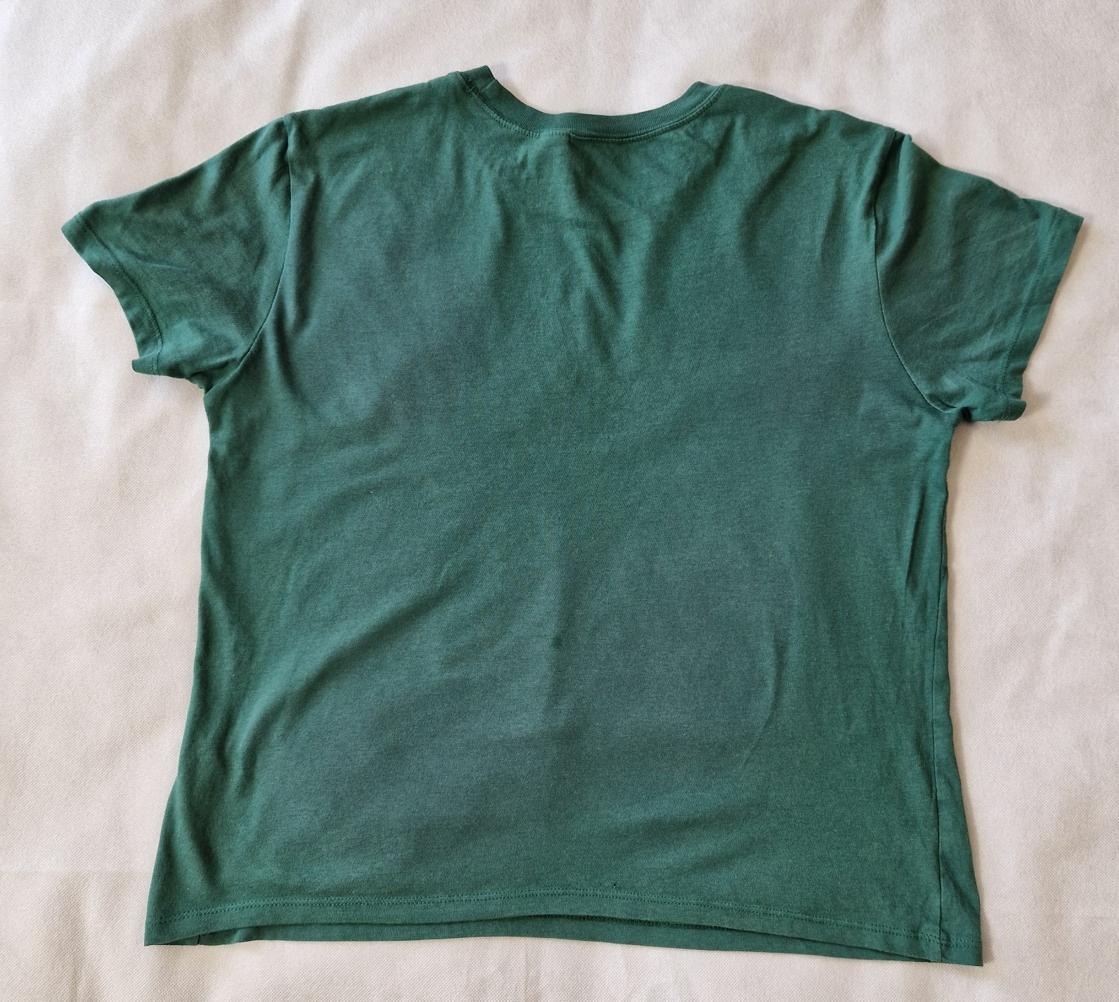 A plain green short-sleeved H&M Divided cotton jersey t-shirt shown from the back.