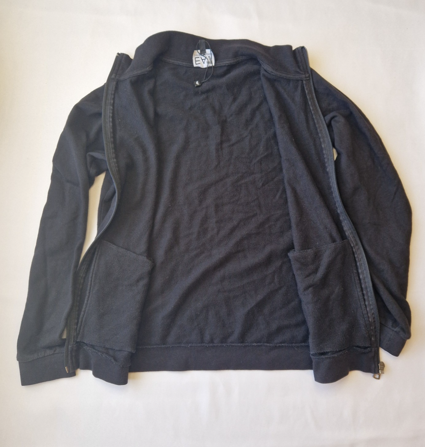 A black EA7 Emporio Armani junior zip-up bomber jacket made from flannel fabric.