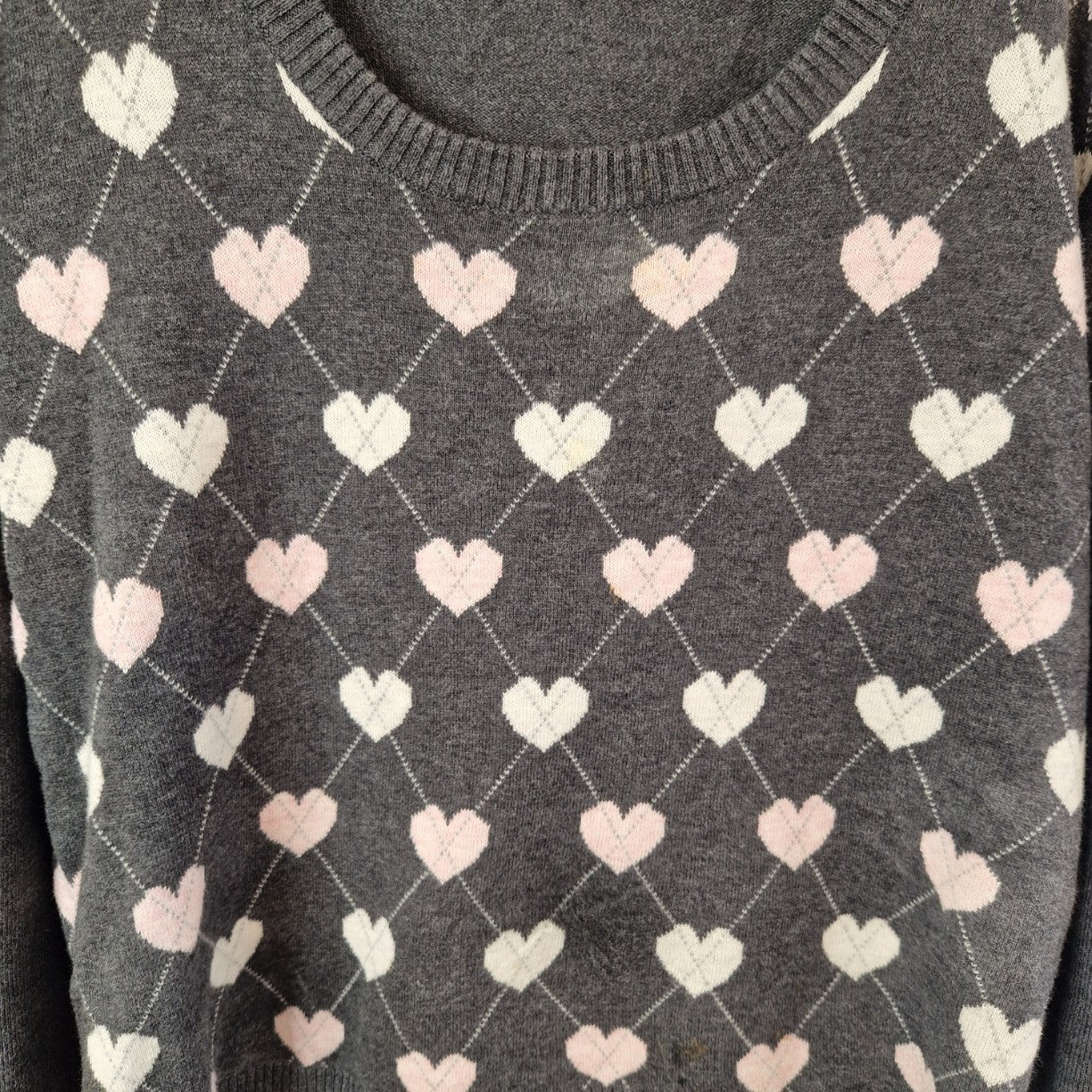 A grey Papaya cotton jumper featuring a repeating white and pink heart pattern and round neckline.