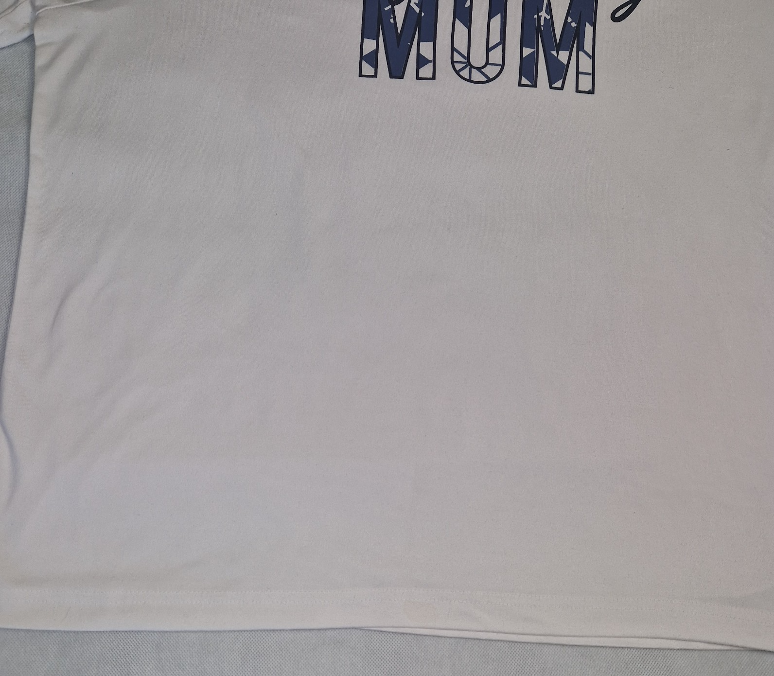 A white cotton jersey t-shirt with the word MUM printed in blue on the chest.