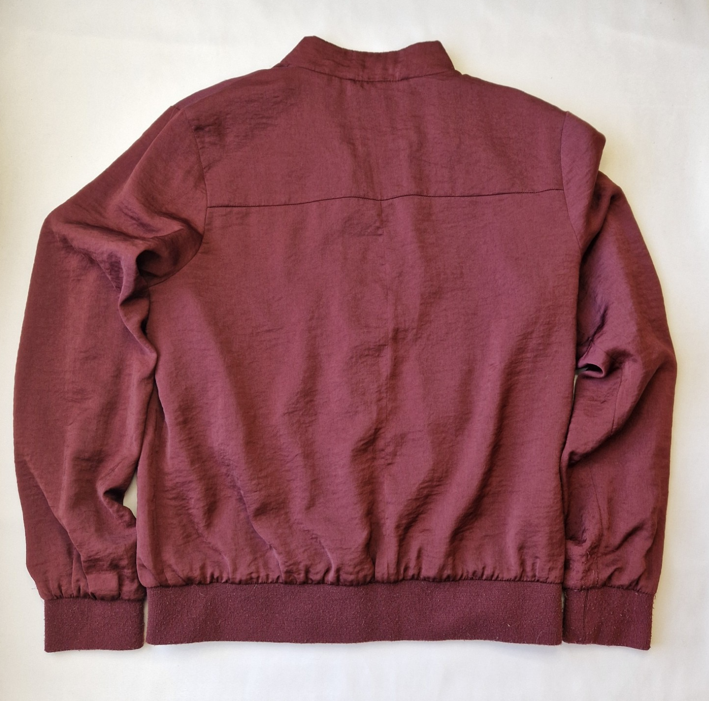 A maroon New Look women's lightweight bomber jacket with a ribbed hem and cuffs.