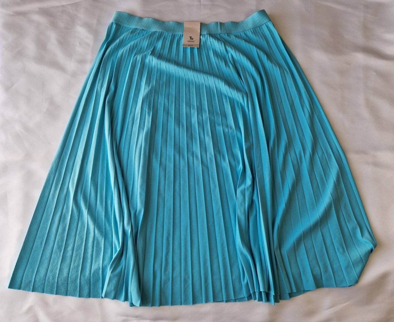 A turquoise pleated midi skirt with an elasticated waistband.