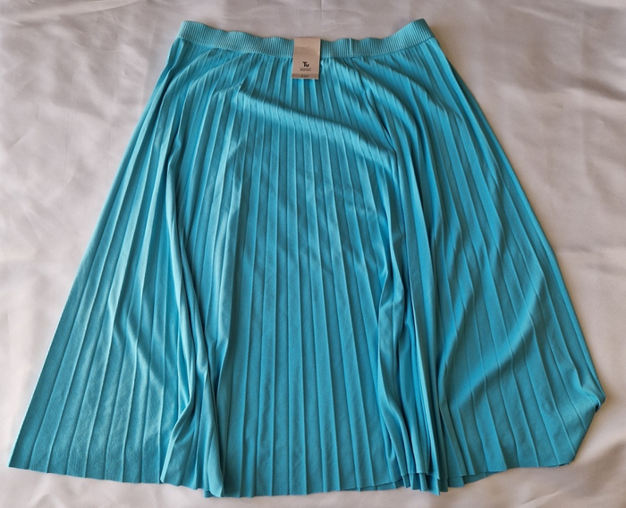A turquoise pleated midi skirt with an elasticated waistband made from lightweight chiffon.