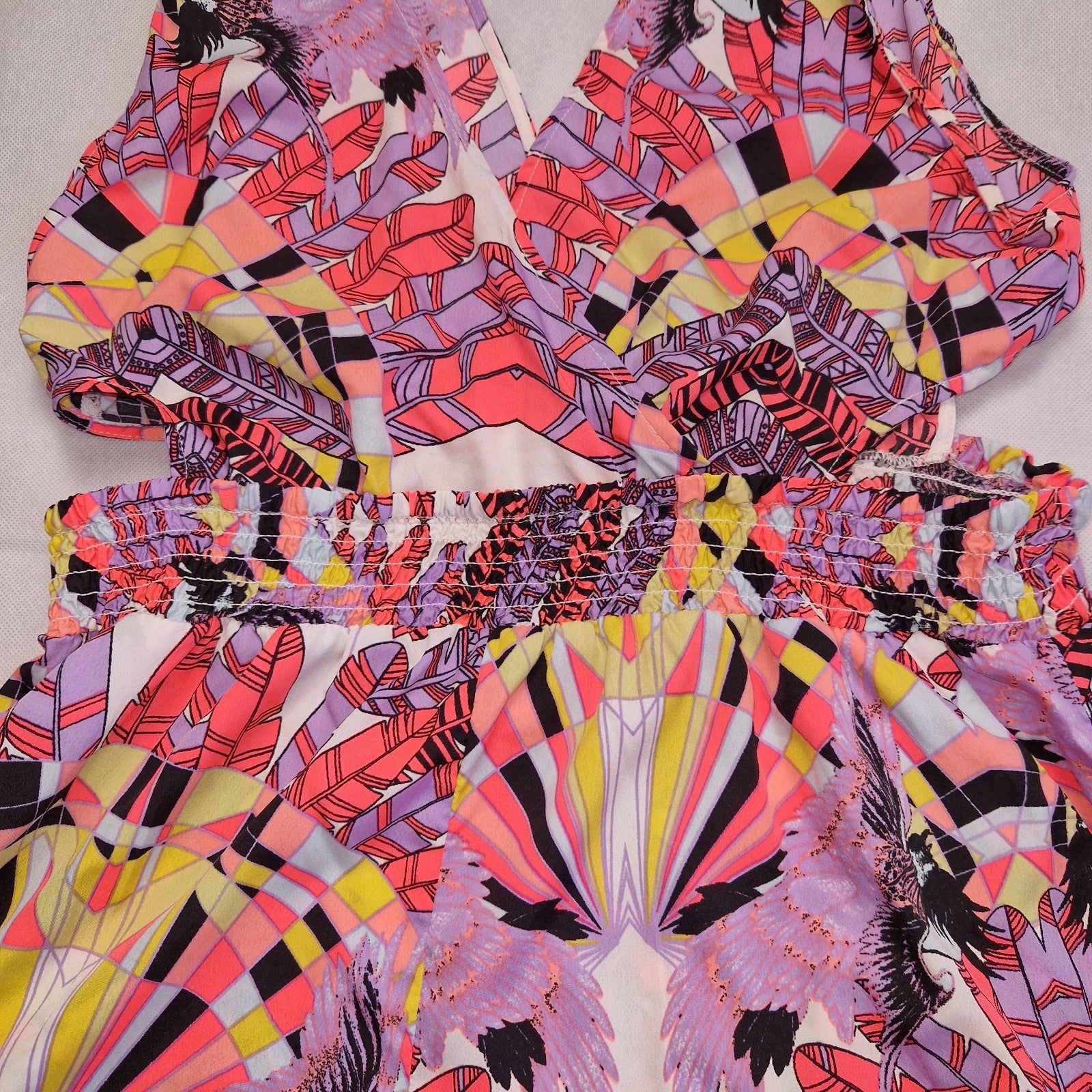 A multicoloured floral print playsuit with an elasticated waist and off-the-shoulder neckline.