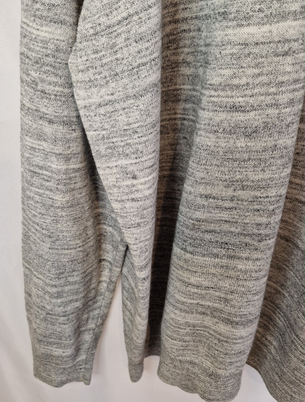 A grey long-sleeve knit pullover with a textured marl finish.