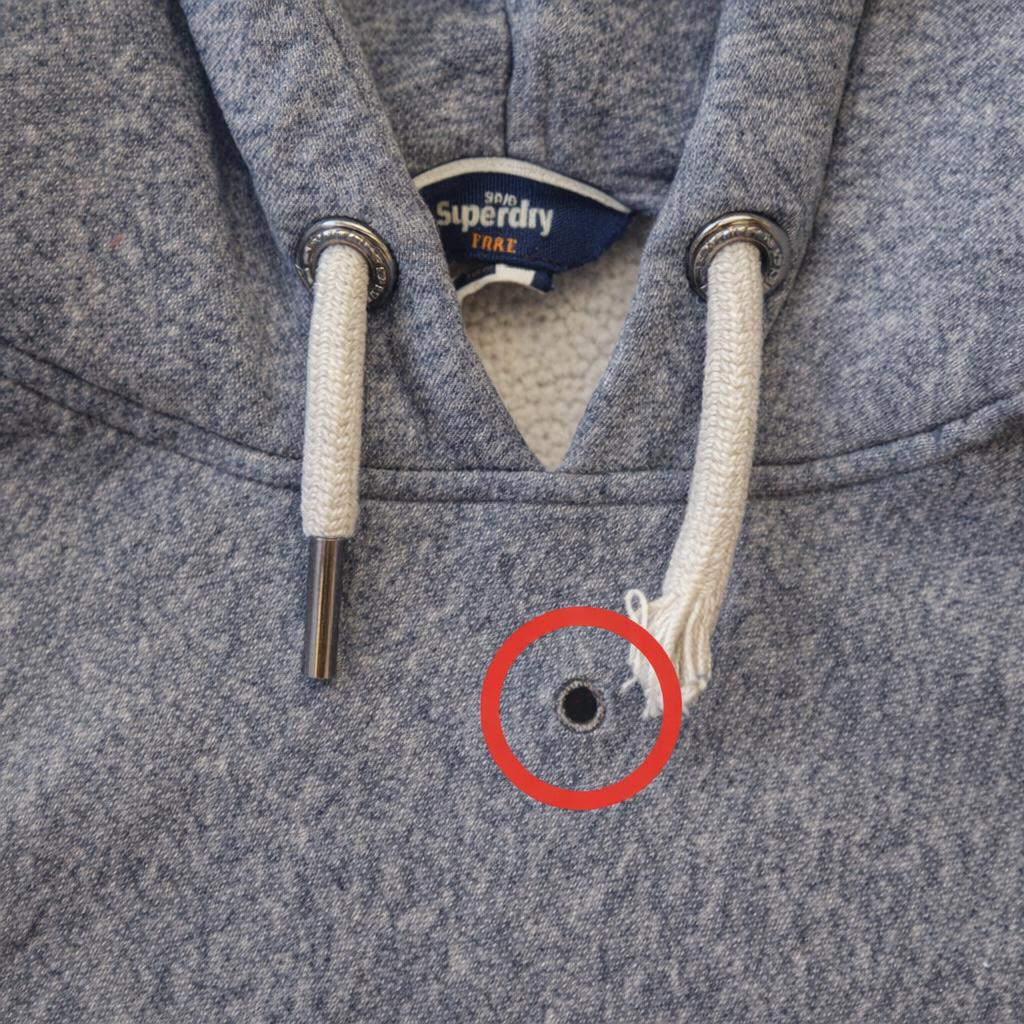 A grey Superdry pullover hoodie with a detached drawstring and a visible metal eyelet.