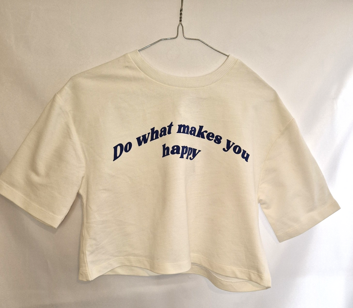 A white short-sleeved cotton t-shirt with the slogan Do what makes you happy in blue text.