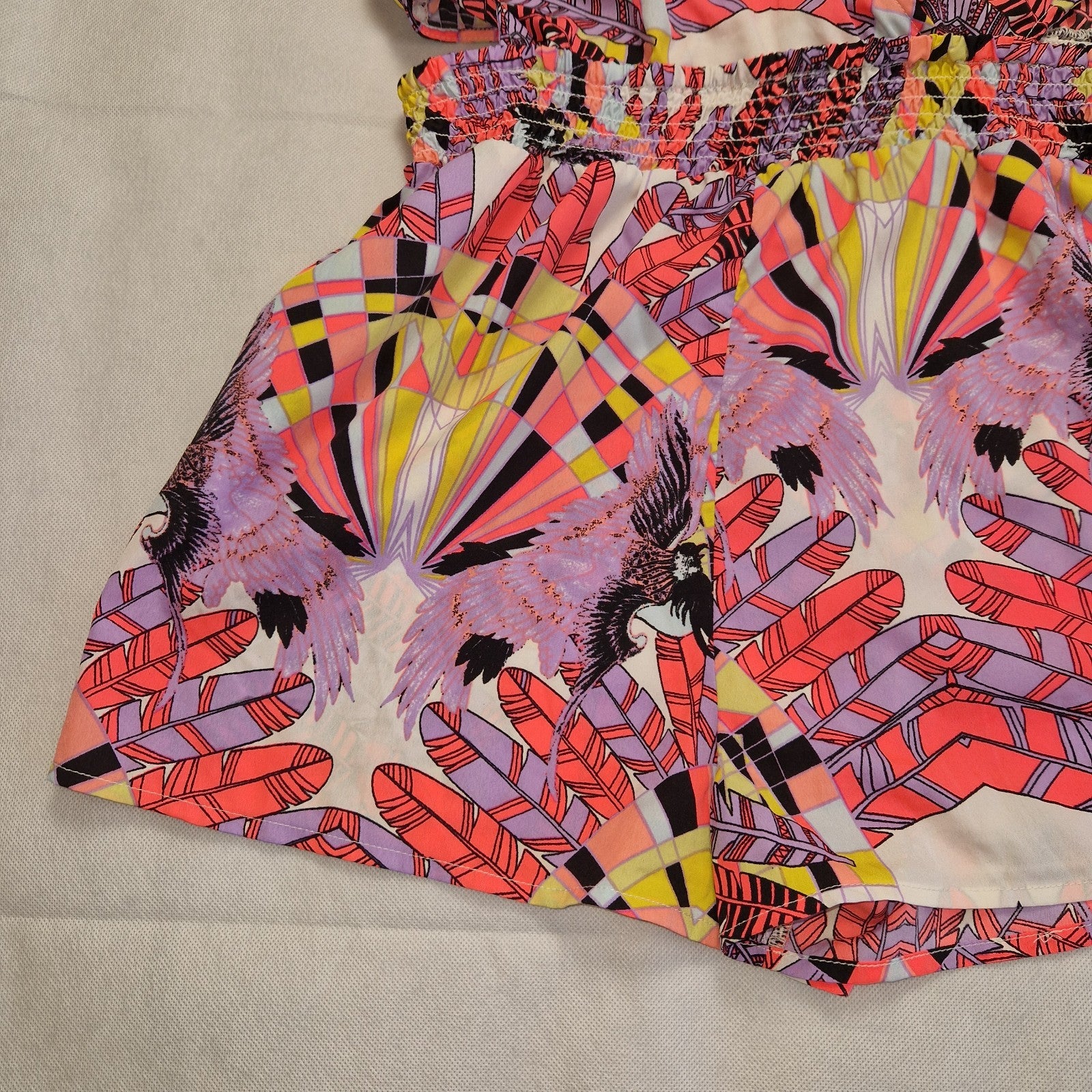 A multicoloured floral print playsuit with an elasticated waist and off-the-shoulder neckline.