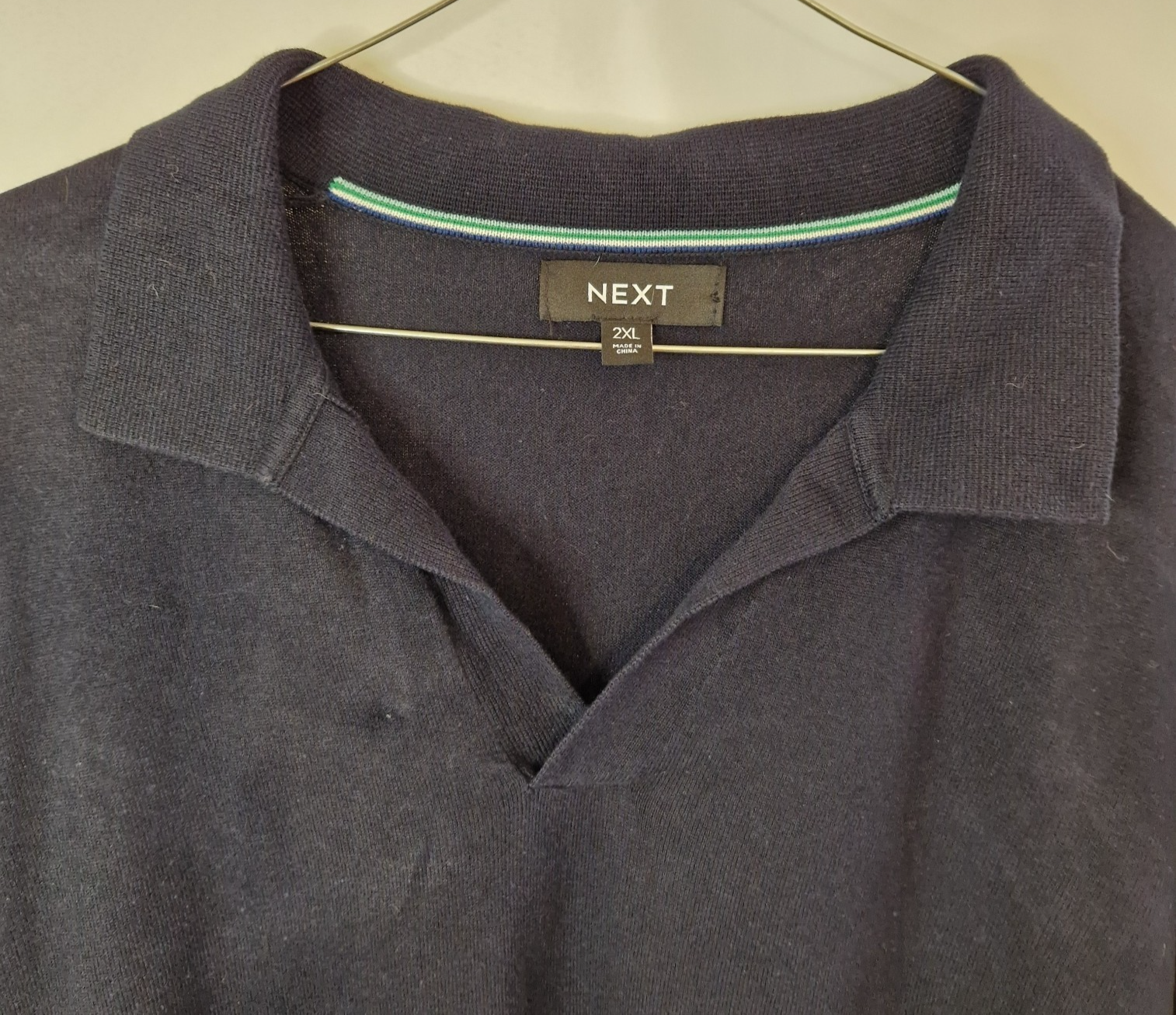 A dark blue Next men's cotton V-neck polo shirt in size 2XL.