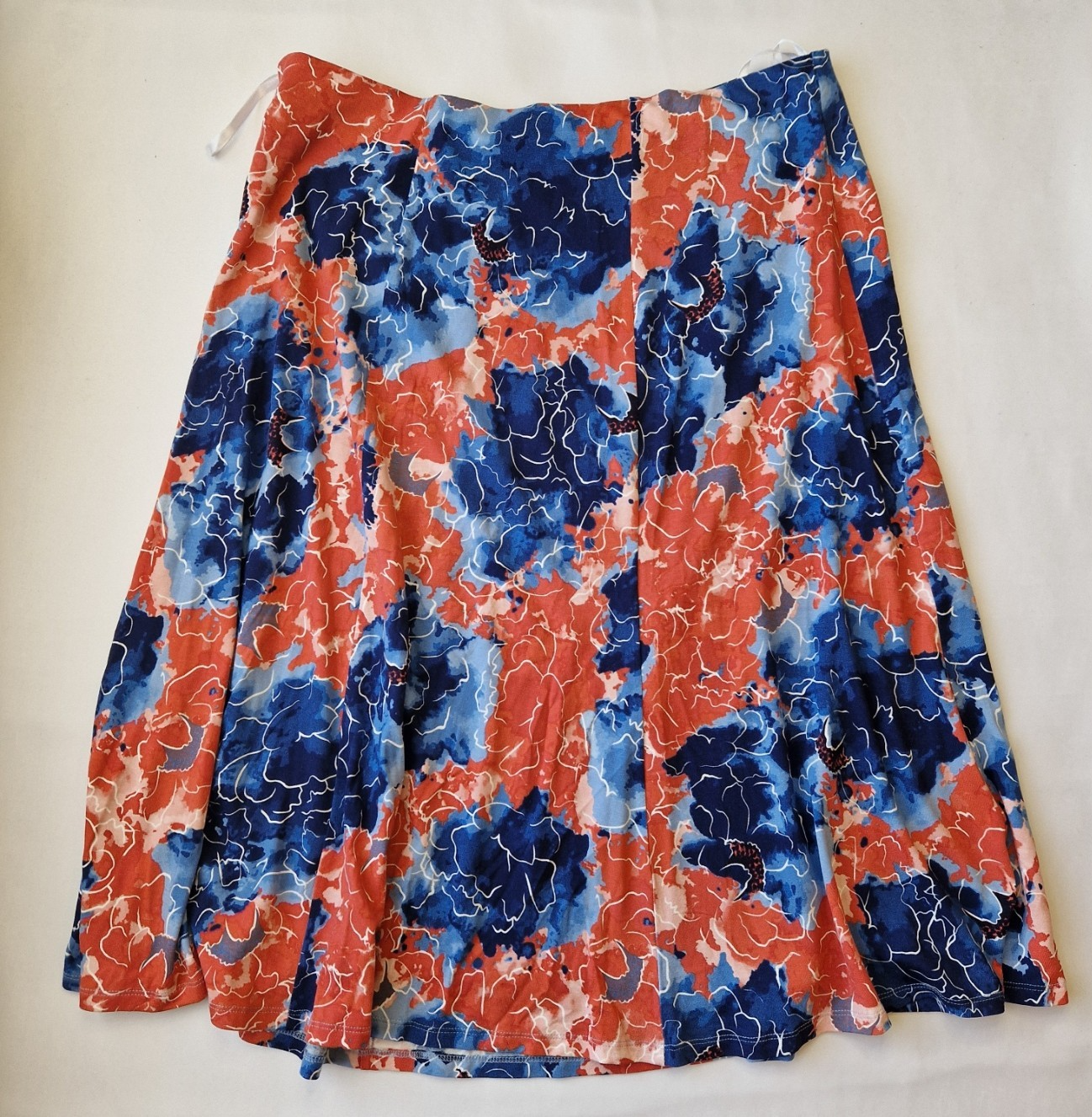 Honor Milburn midi skirt in a multicolour floral print with an asymmetric hem.