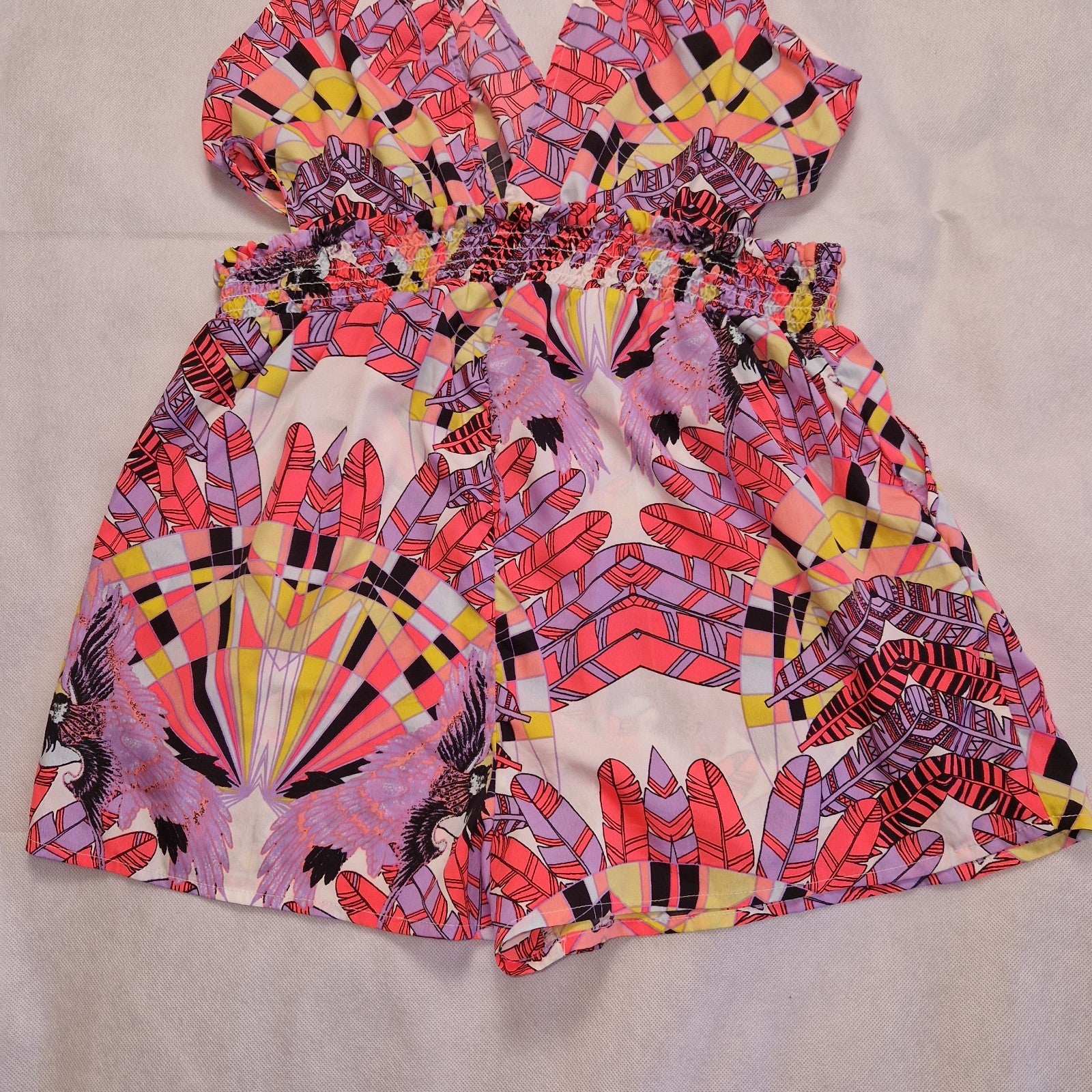 A multicoloured floral print playsuit with an off-the-shoulder neckline and elasticated waist.
