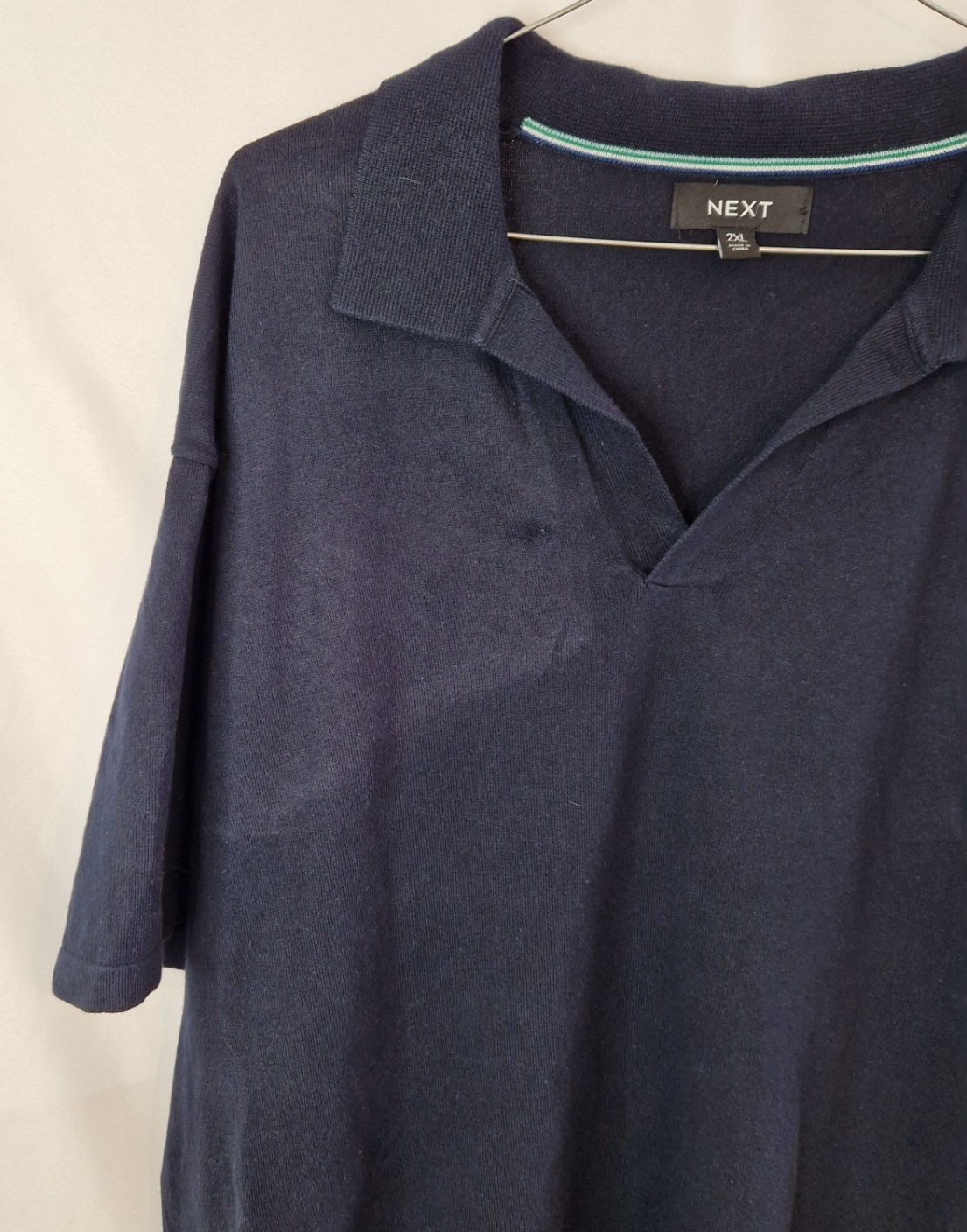 A dark blue Next men's short-sleeve cotton polo shirt featuring a V-neck collar in size 2XL.