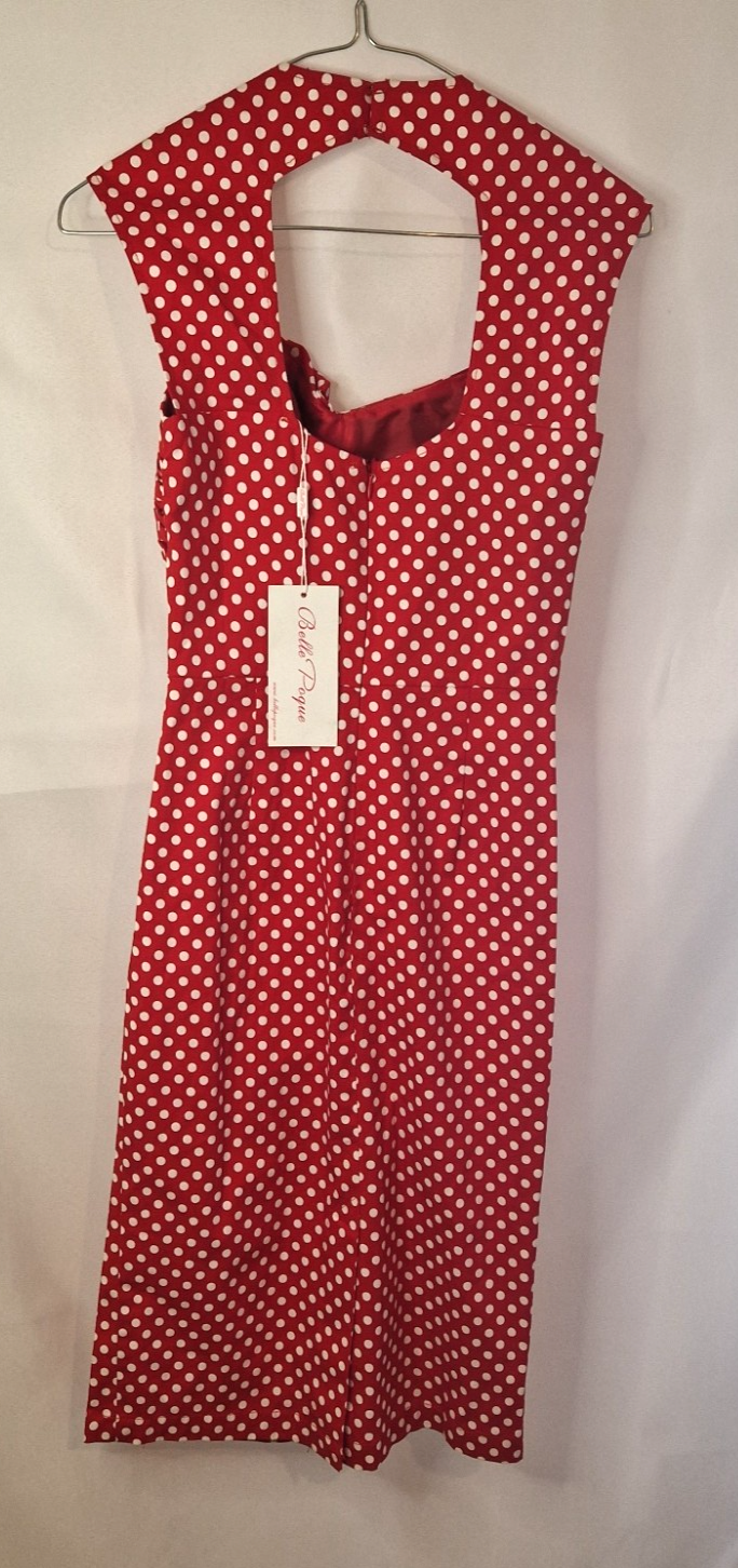 A red and white polka dot vintage-style halter dress with a fit and flare silhouette.